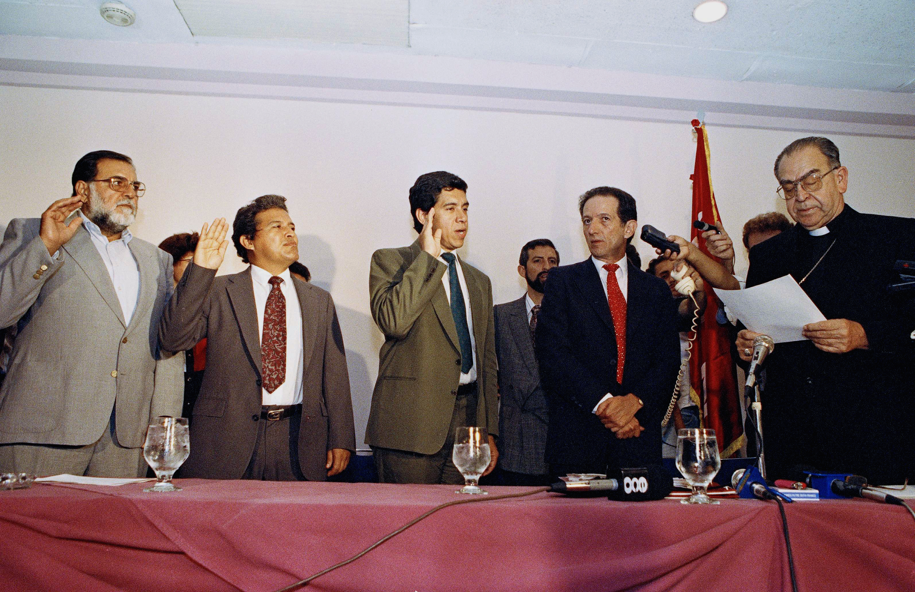 Commanders of the FMLN, including Schafik Hándal (L), are sworn in by Archbishop Arturo Rivera y Damas in San Salvador in 1992 as the group becomes a political party, on September, 2, 1992