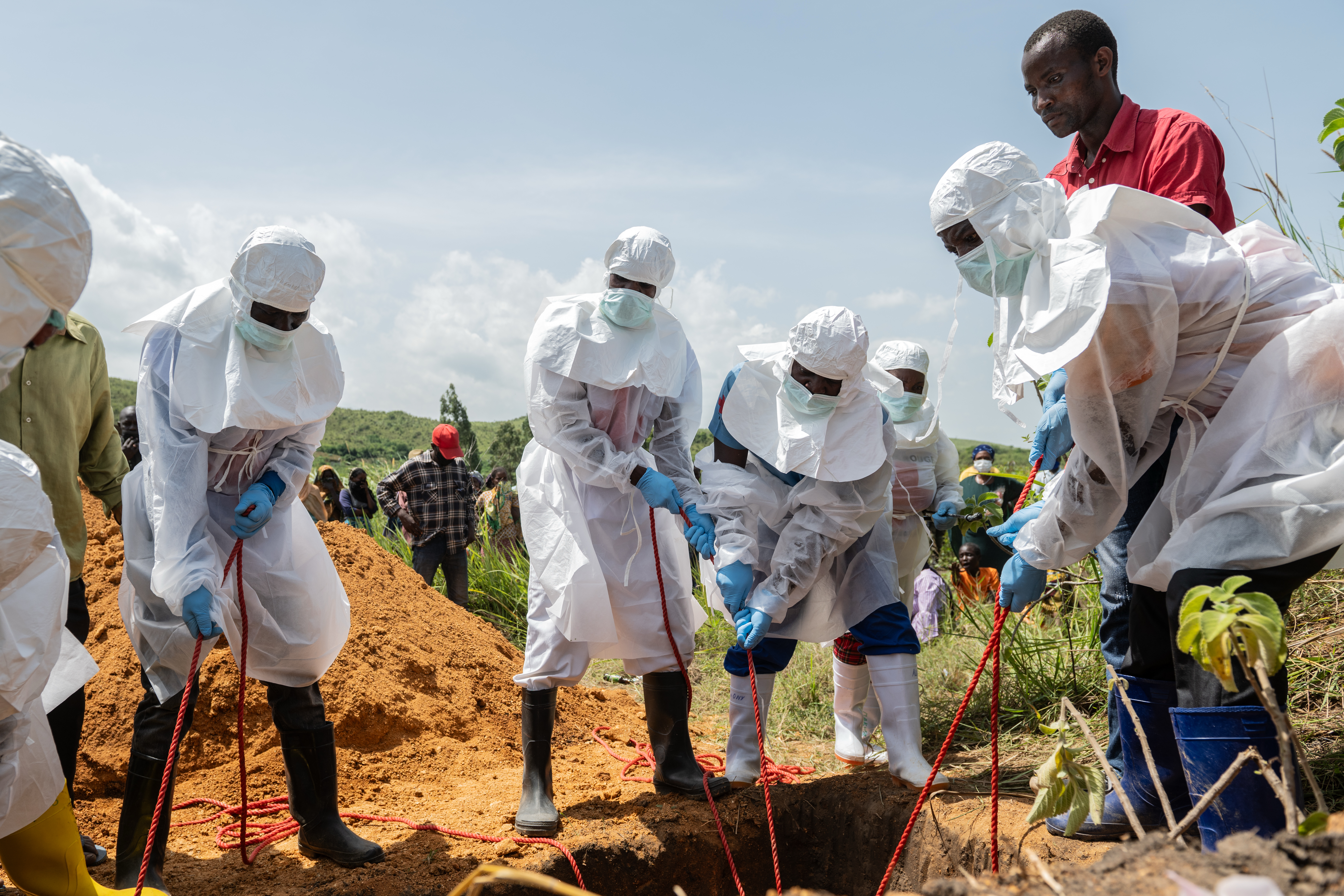 Red Cross workers bury an Ebola victim at the Rwampara Cemetery, in Bunia, Congo, Saturday, May 23, 2026. (AP Photo/Moses Sawasawa)