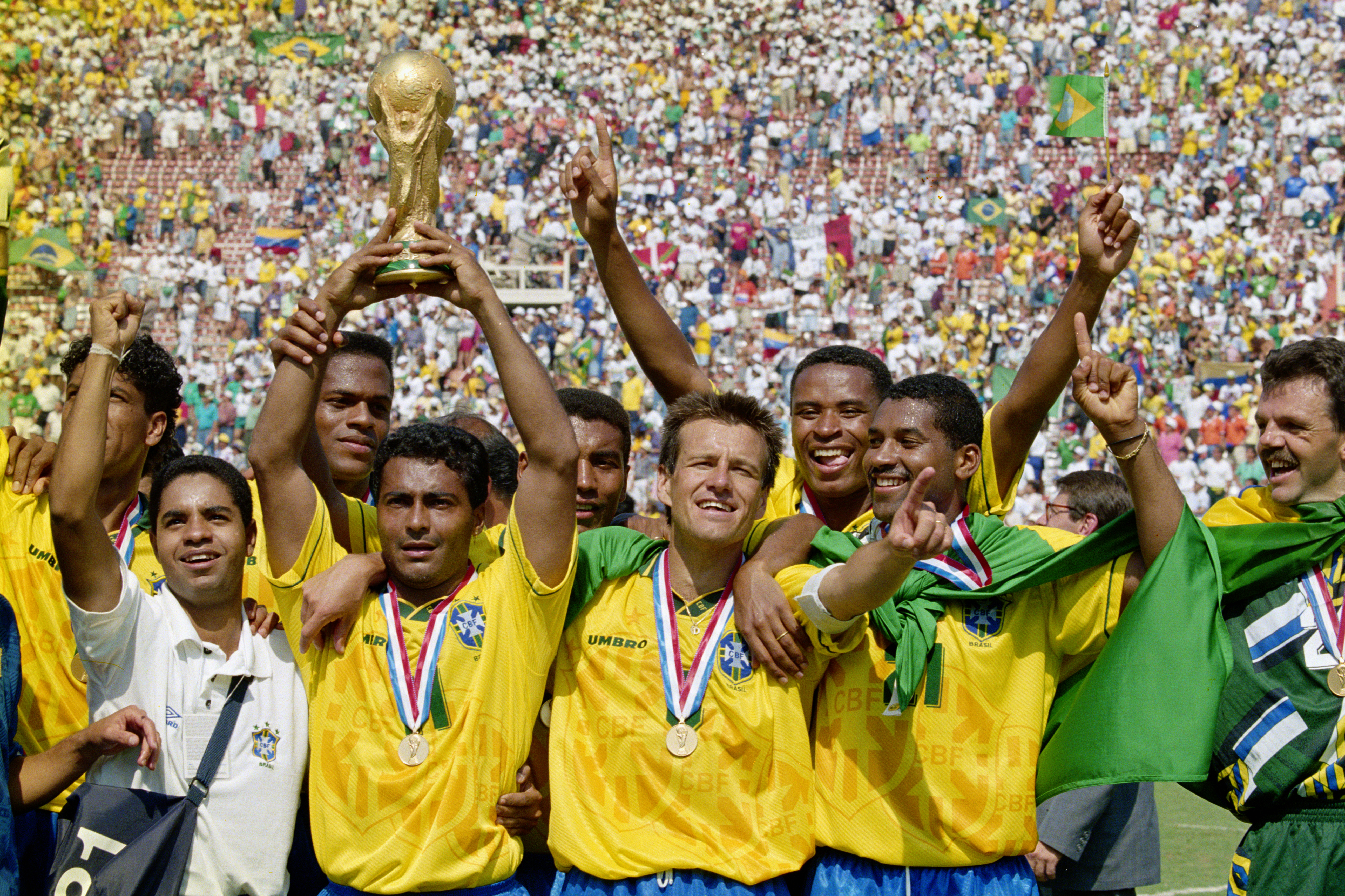 Romario (with trophy) and captain Dunga of Brazil and the Brazilian team celebrate after winning the1994 FIFA World Cup Final against Italy on 17 July 1994 played at the Rose Bowl in Pasadena, California, United States. Brazil defeated Italy 3-2 in a penalty shootout.(Photo by Ben Radford/Getty Images)