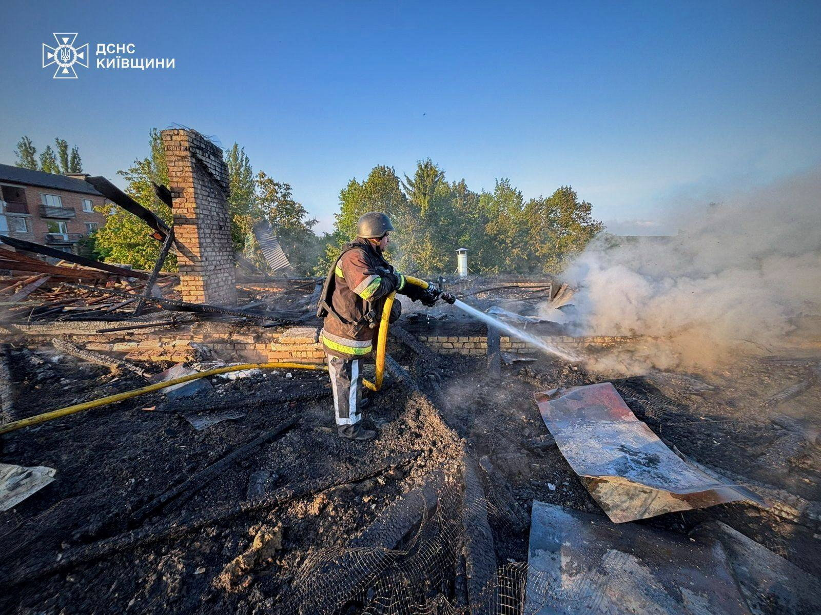 A firefighter works at the site of a kindergarten damaged during a Russian drone strike, amid attacks on Ukraine, in Kyiv