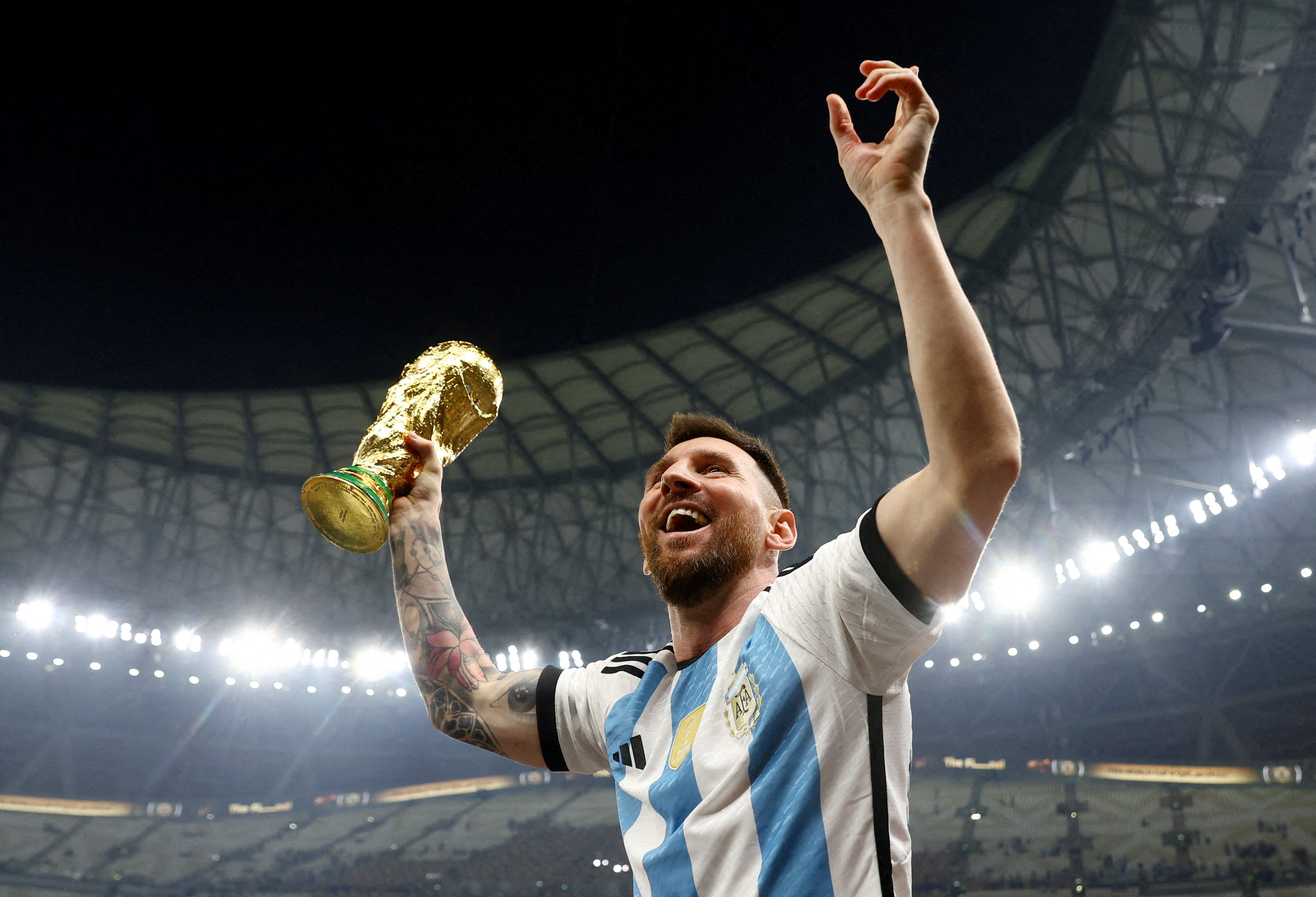 Argentina's Lionel Messi celebrates winning the World Cup with the trophy