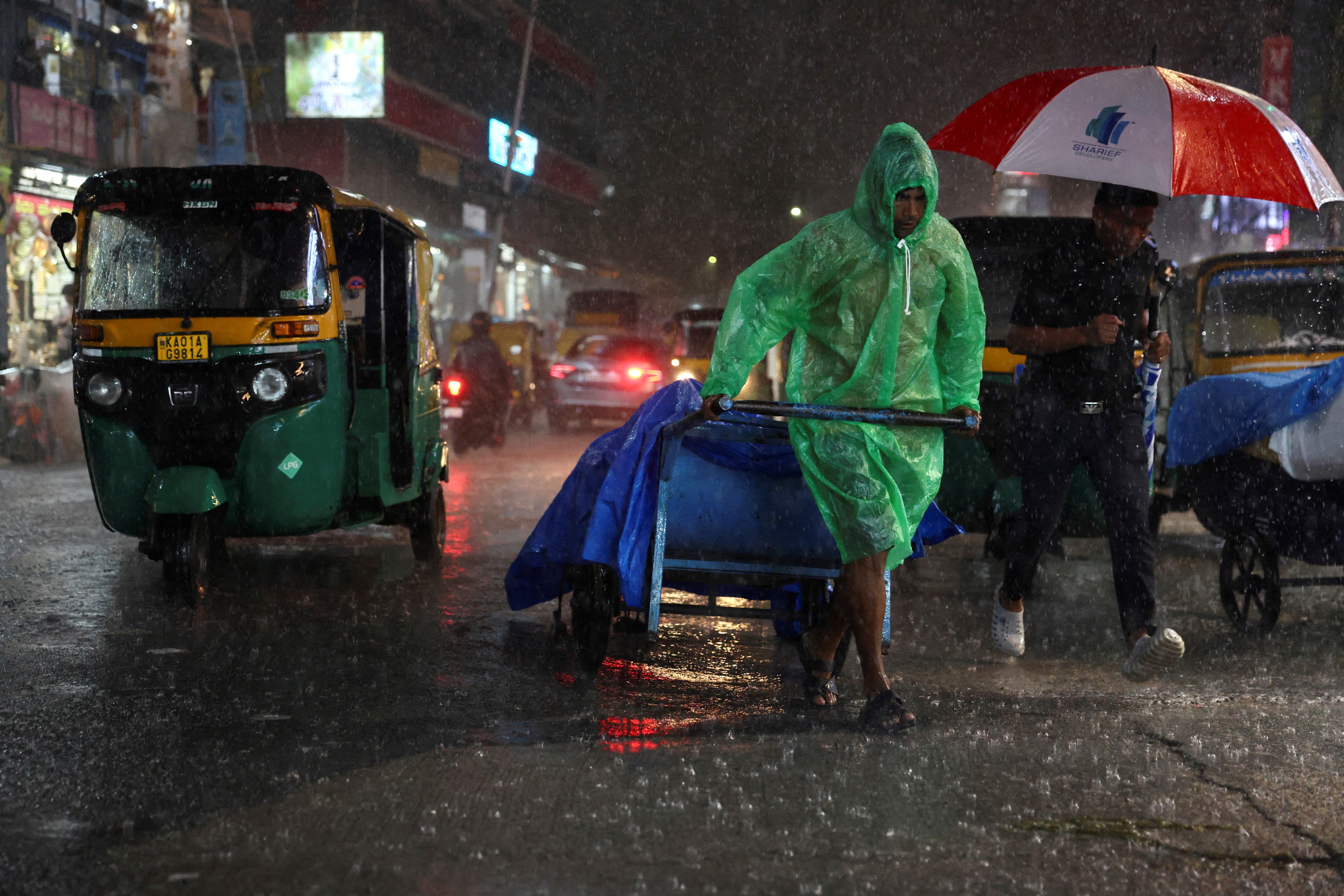 A man pulls a cart packed with goods during rain in Bengaluru, India, September 3, 2025.