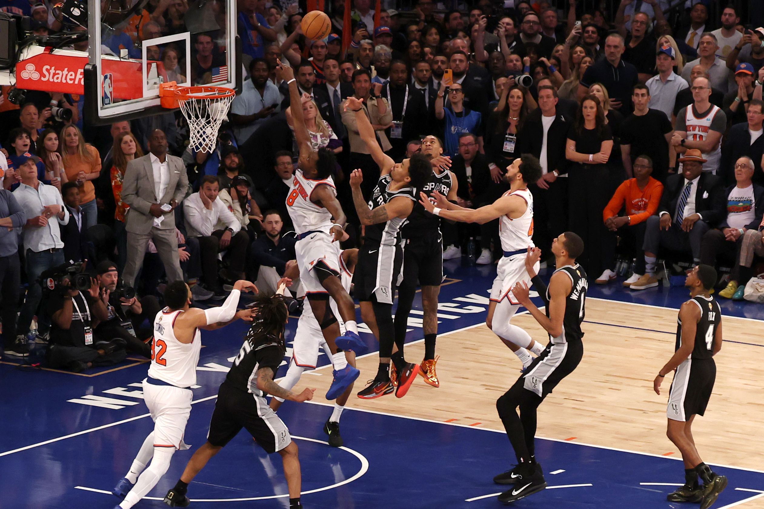 Jun 10, 2026; New York, New York, USA; New York Knicks forward Og Anunoby (8) scores on a rebound against San Antonio Spurs guard Dylan Harper (2) in the fourth quarter during game four of the 2026 NBA Finals at Madison Square Garden. Mandatory Credit: Geoff Burke-Imagn Images