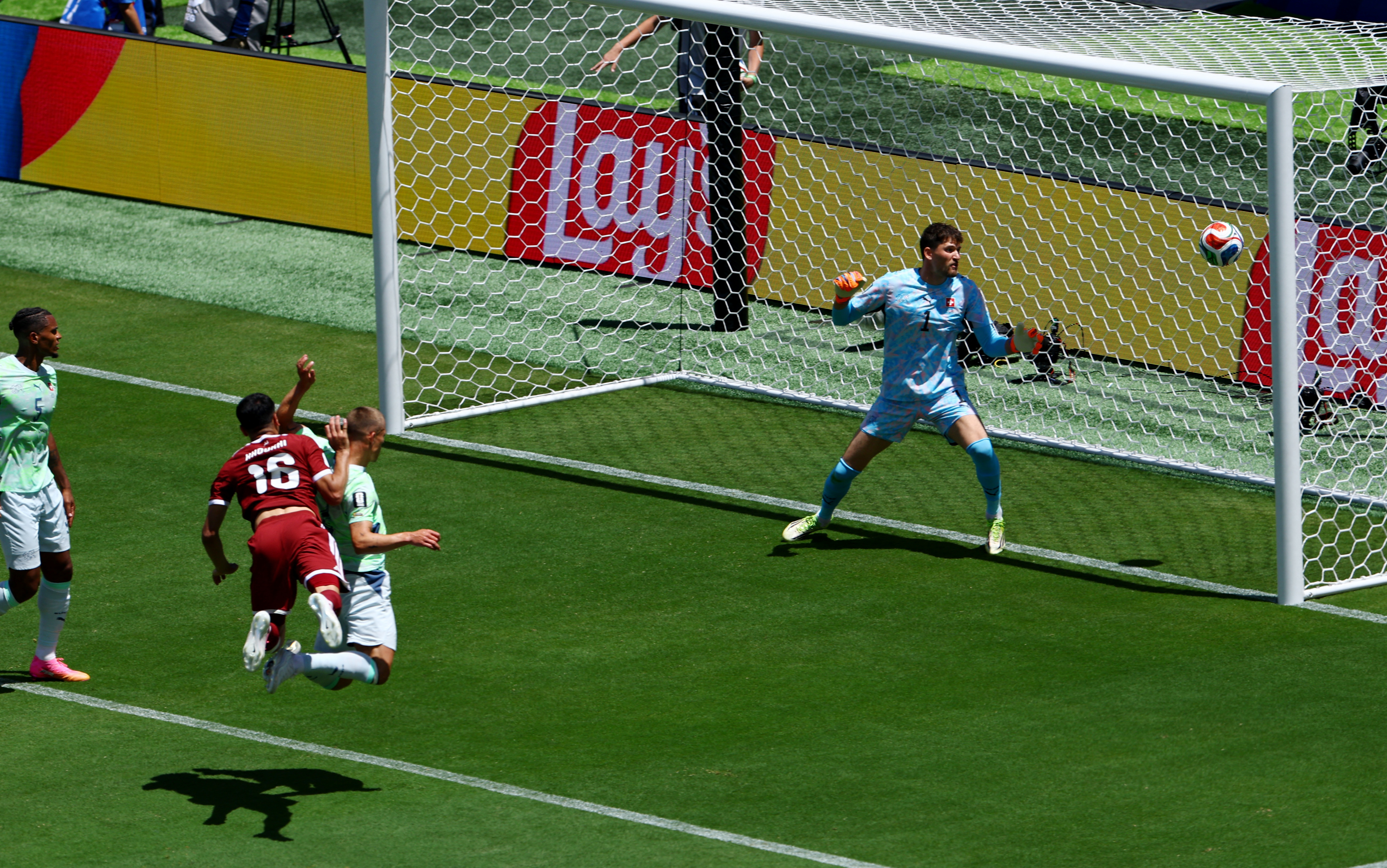 Qatar's Boualem Khoukhi scores their first goal past Switzerland's Gregor Kobel