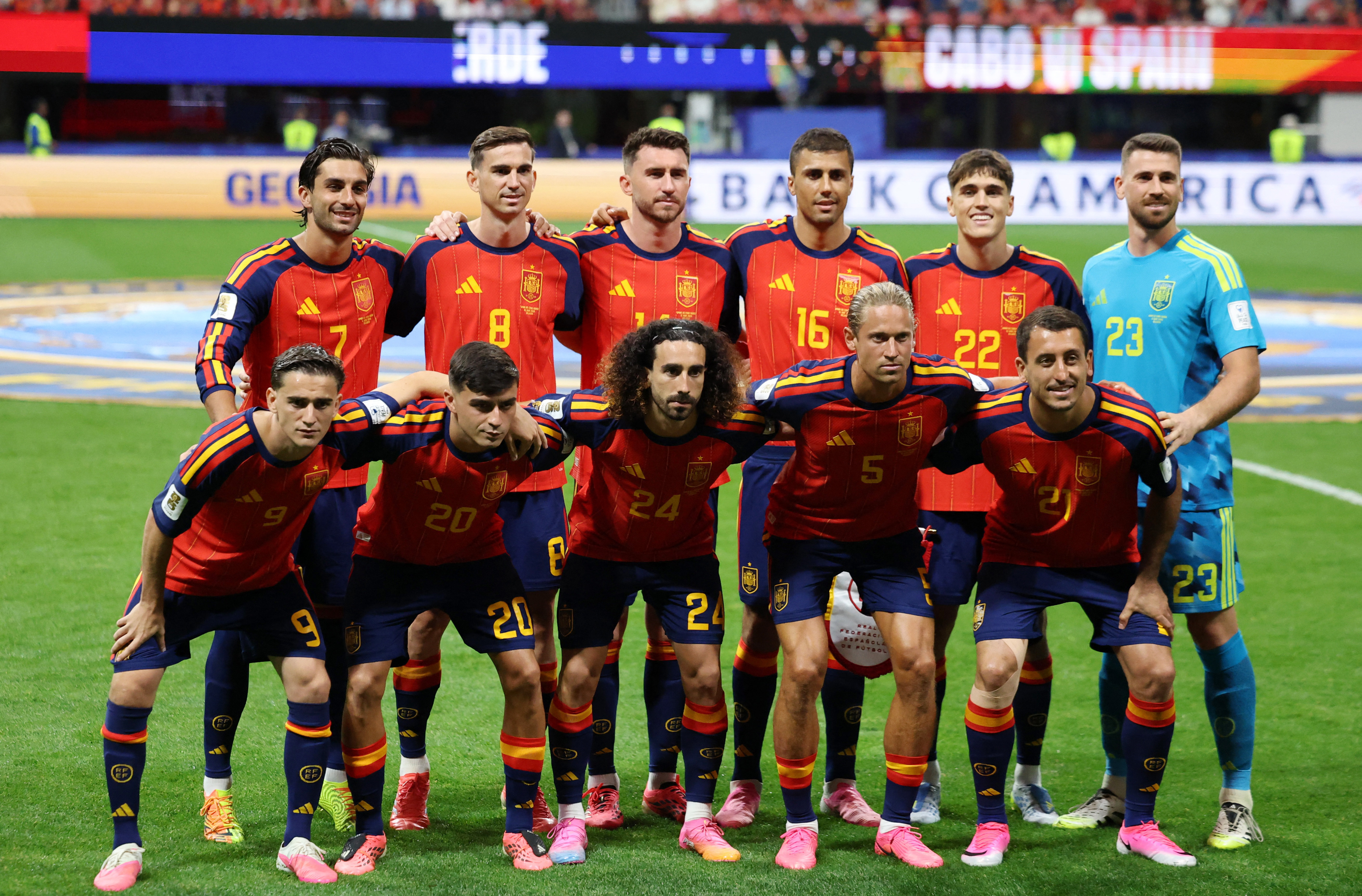Spain players pose for a team photo on the field.