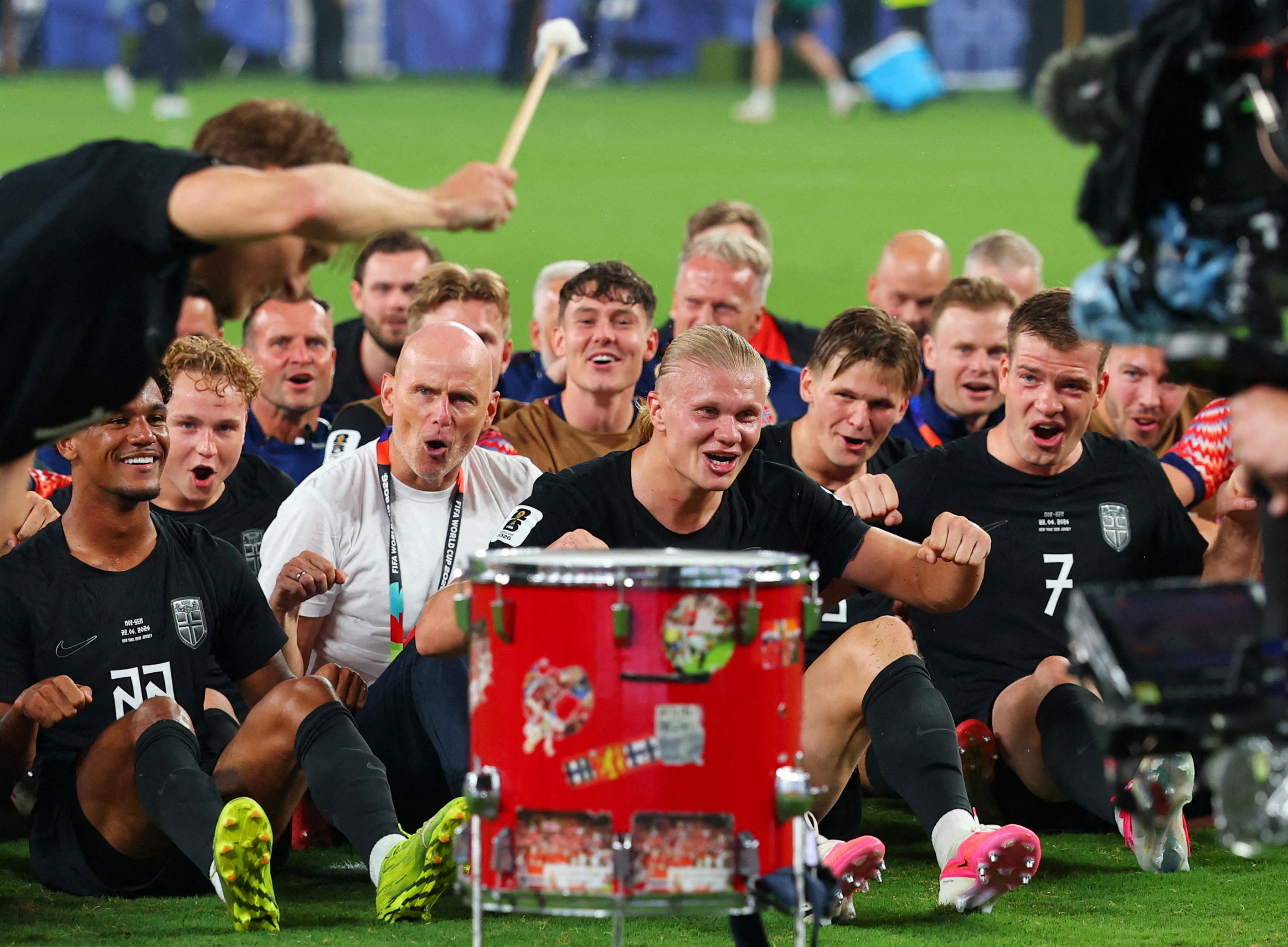 Norway's players and coaching staff perform a rowing-style celebration together on the pitch