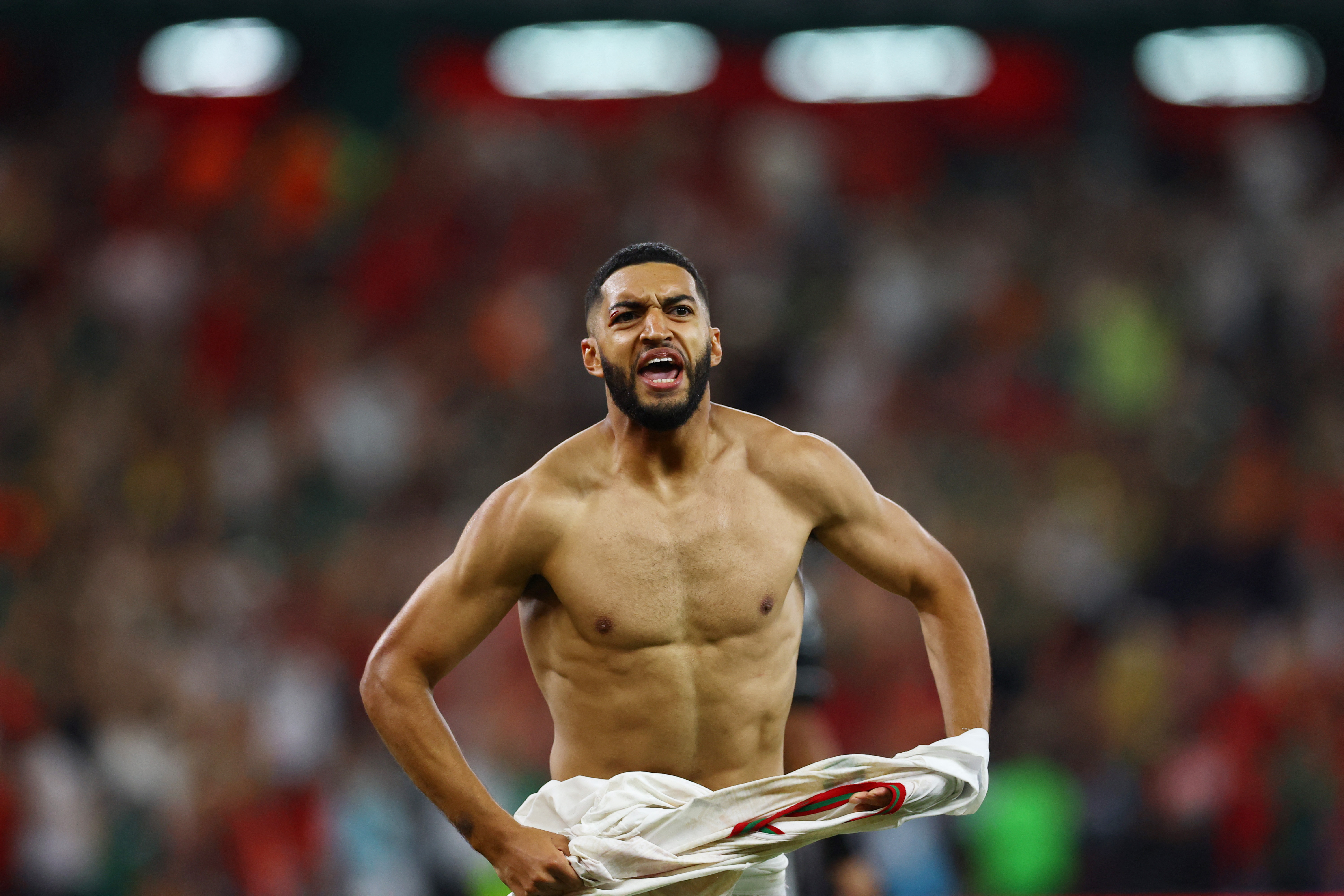 Morocco's Ismael Saibari celebrates with arms raised after scoring the winning penalty against the Netherlands