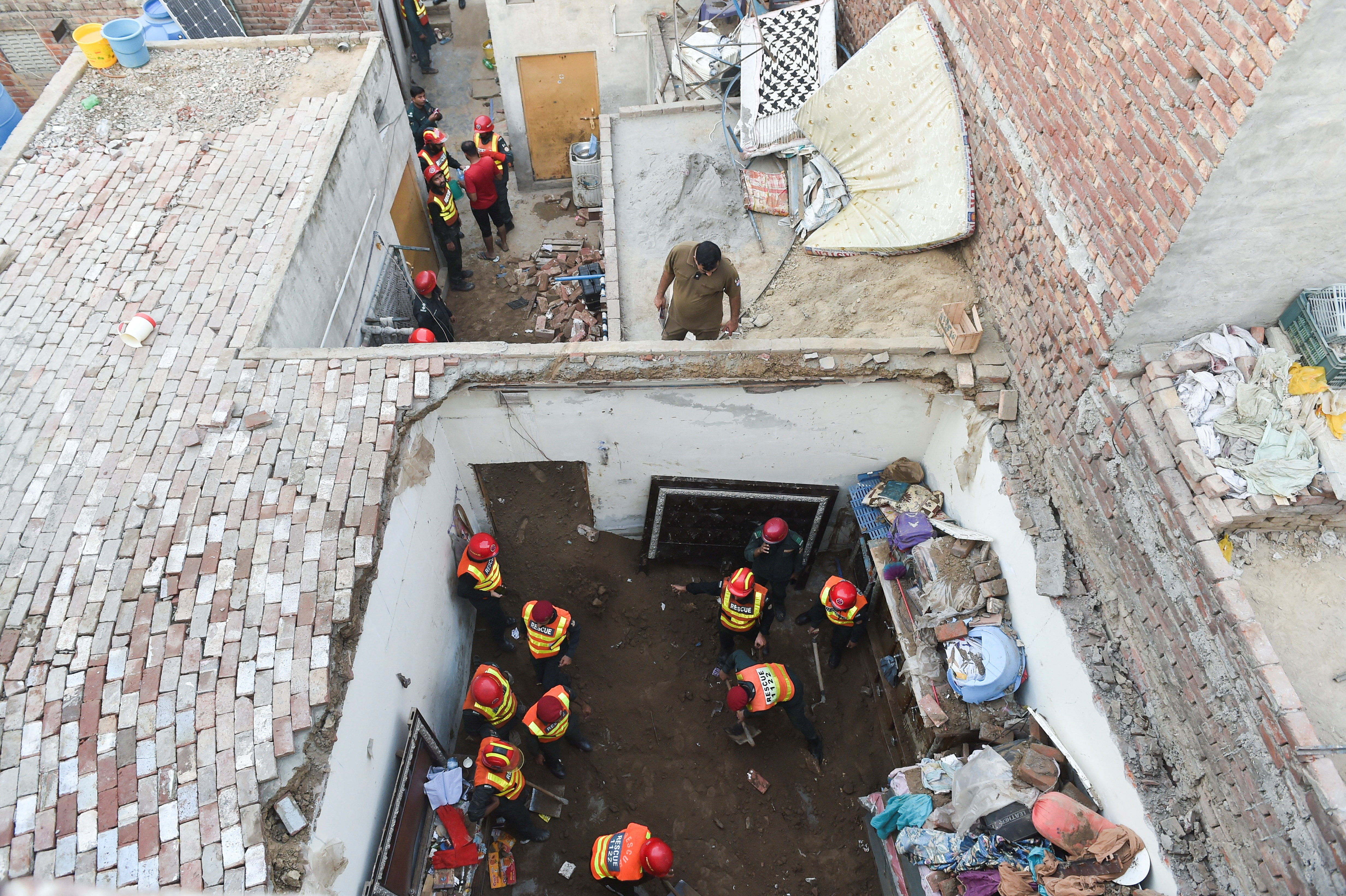Rescue workers work at the site where children reportedly died after a tuition centre's roof collapsed in Lahore, Pakistan on June 30, 2026.