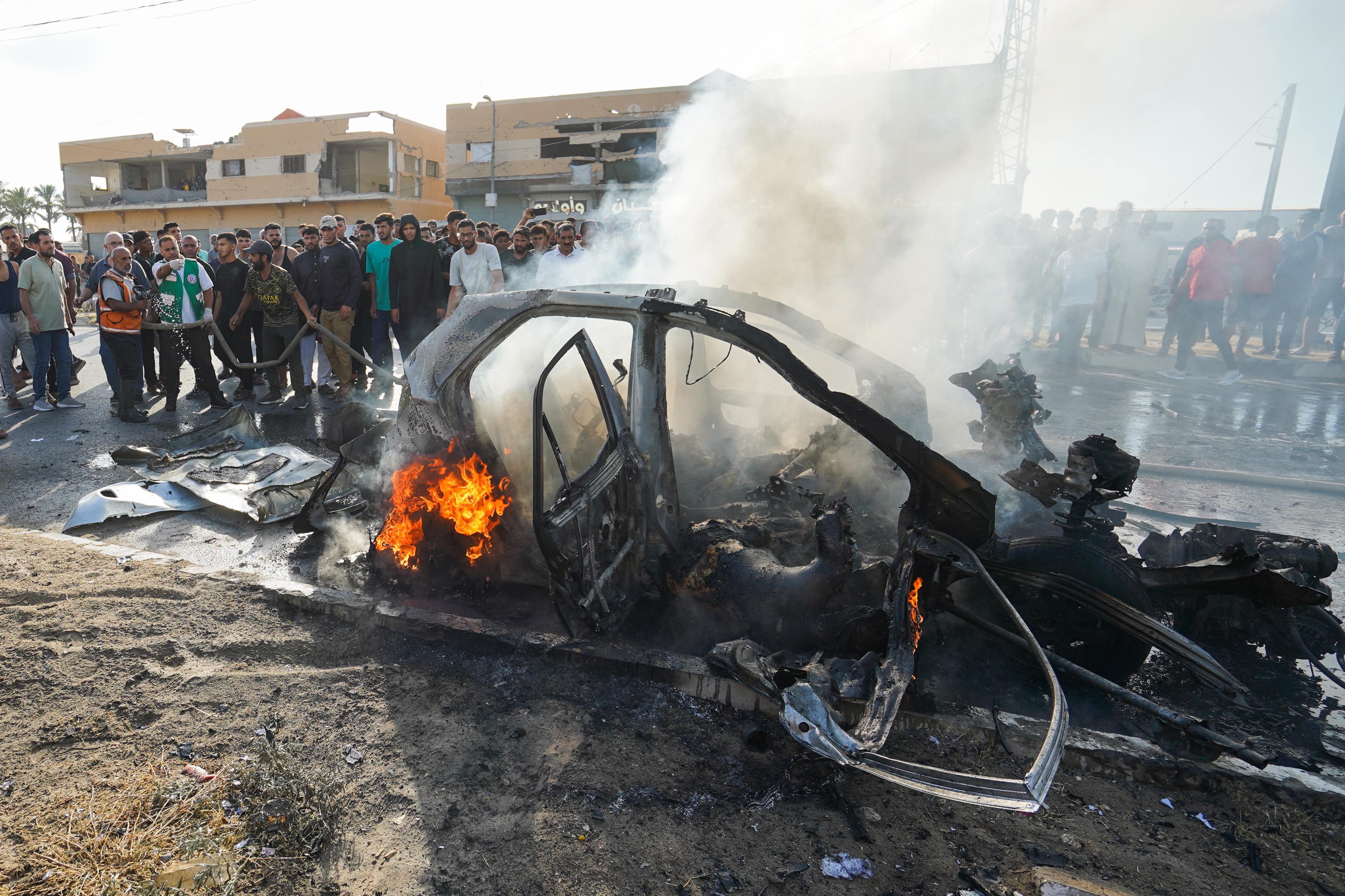 A view of a burned-out vehicle on Salah al-Din Street in central Gaza, Palestine following an Israeli strike on June 26, 2026. Three Palestinians were killed after Israeli forces targeted a civilian vehicle in an attack described as a violation of the ceasefire. The vehicle caught fire as a result of the strike, while medical, civil defense and firefighting teams were dispatched to the area. ( Adam Bilal - Anadolu Agency )