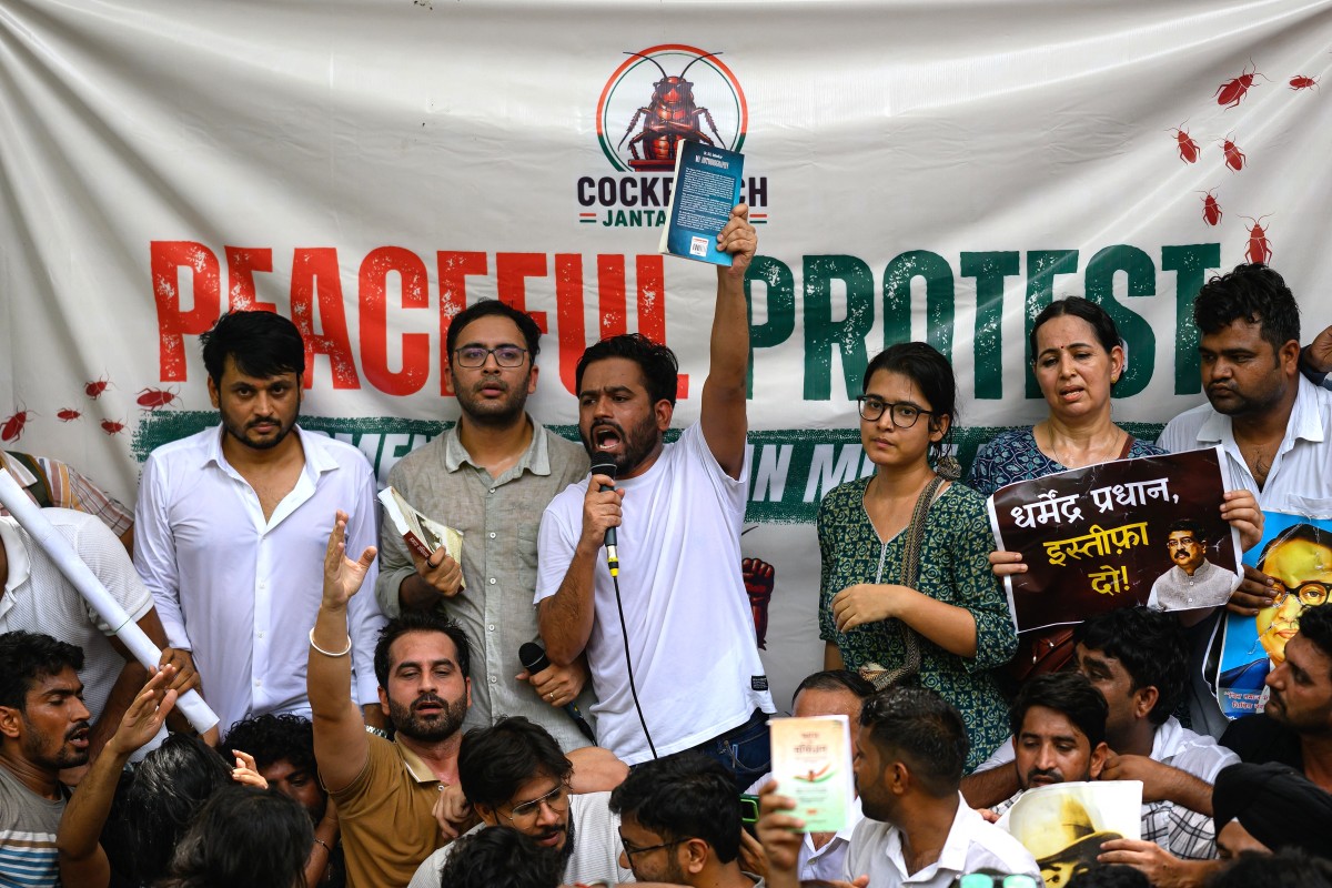 Cockroach Janta Party (CJP) founder Abhijeet Dipke (C) shouts slogans during a protest
