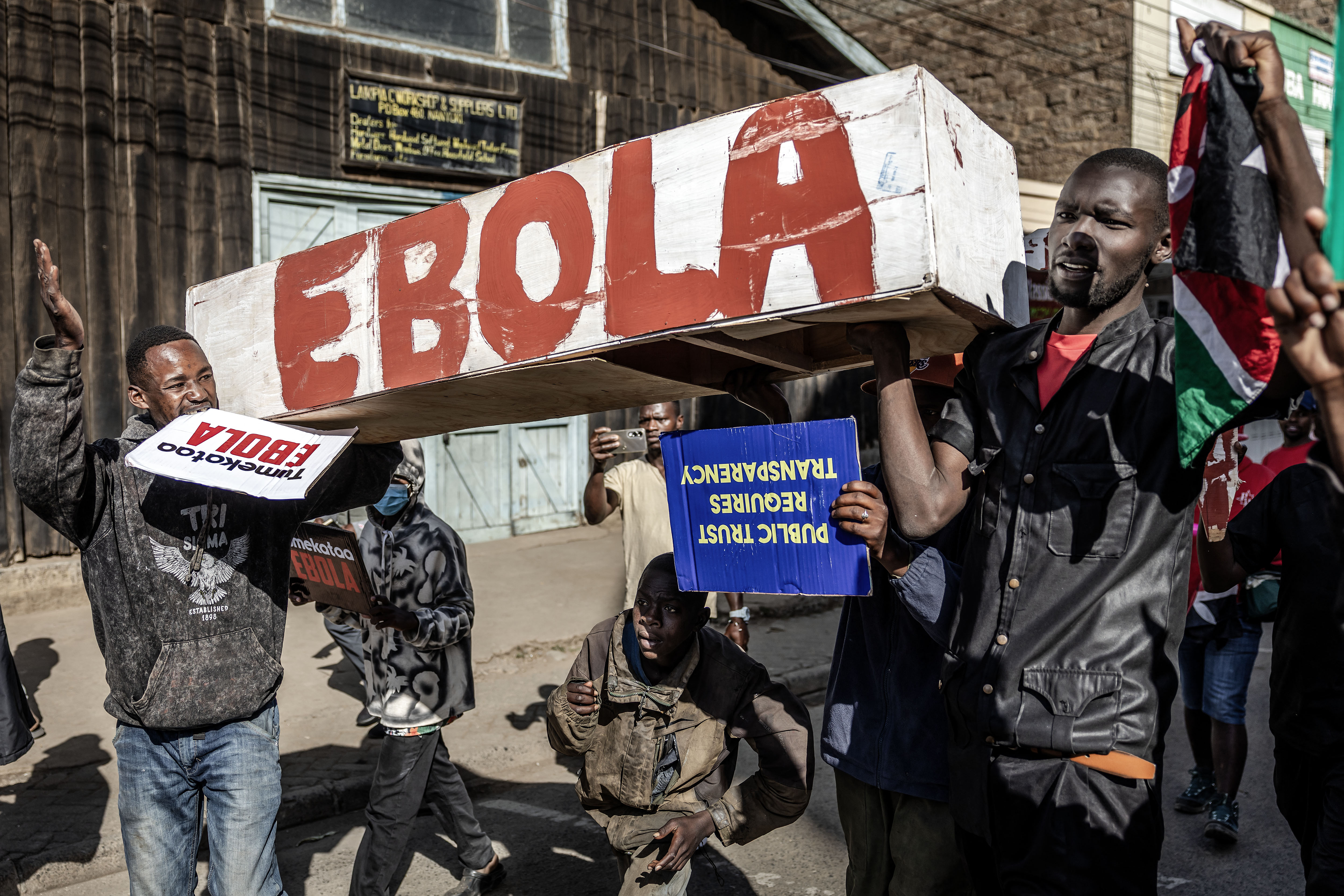 Protesters carry a mock coffin as they march during a demonstration against a controversial US-built Ebola quarantine centre in Nanyuki, Kenya