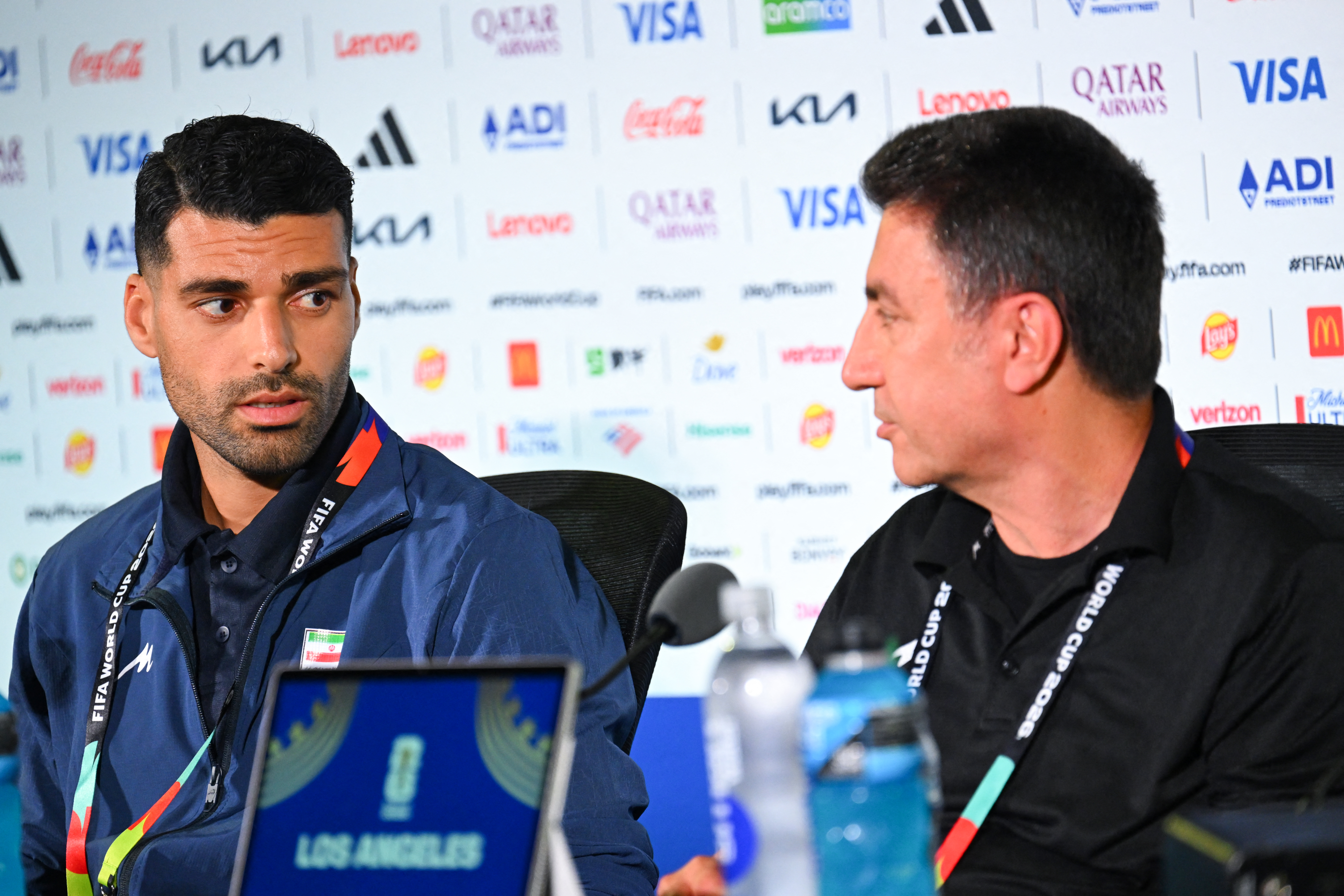 Iran's head coach Amir Ghalenoei (R) gives a press conference next to Irans forward #09 Mehdi Taremi at Los Angeles Stadium in Inglewood on June 14, 2026, on the eve of the 2026 World Cup football match between Iran and New Zealand. (Photo by Patrick T. FALLON / AFP)