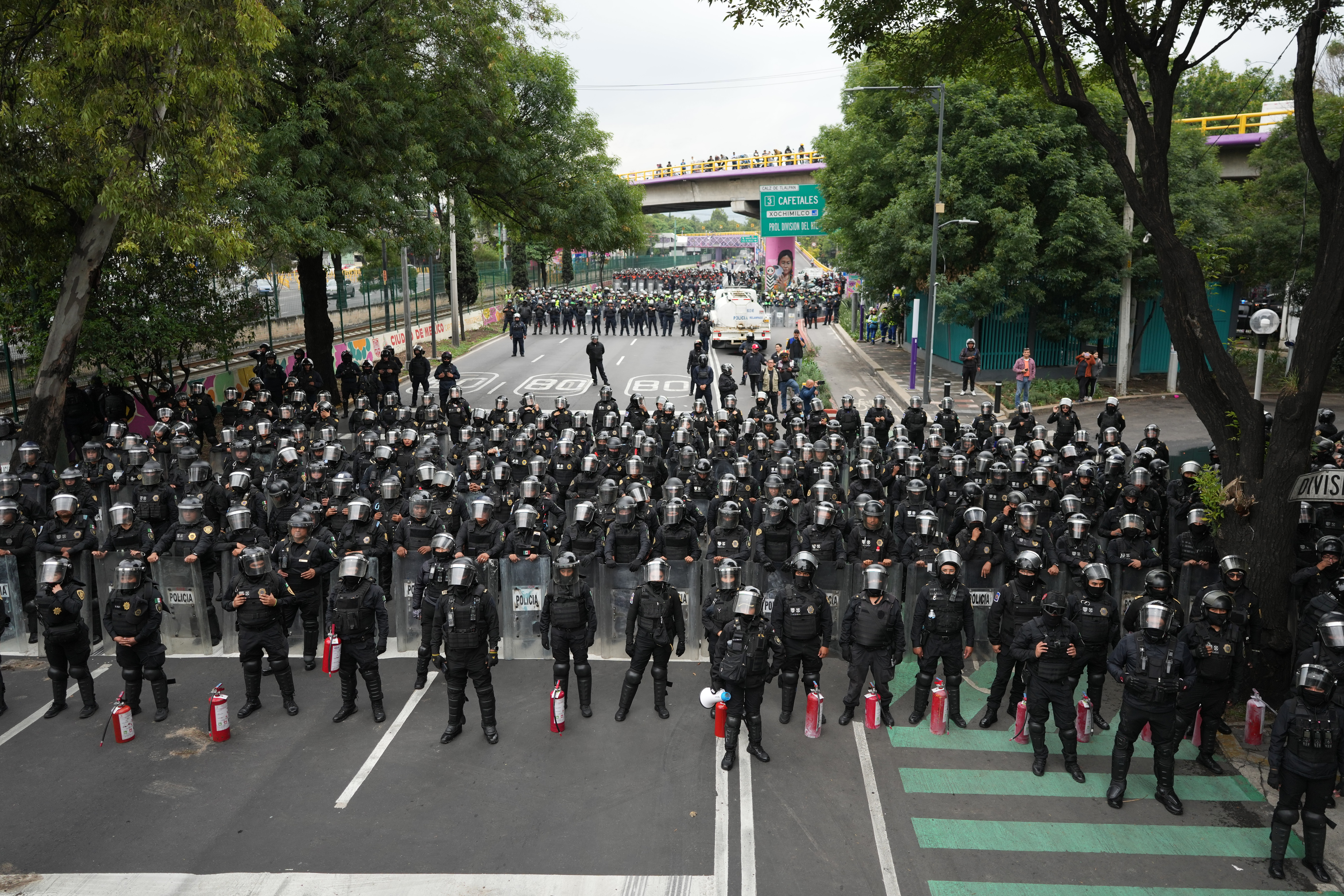Police block an avenue to prevent protesting teachers from marching to the stadium that will host the opening match of the FIFA World Cup in Mexico City