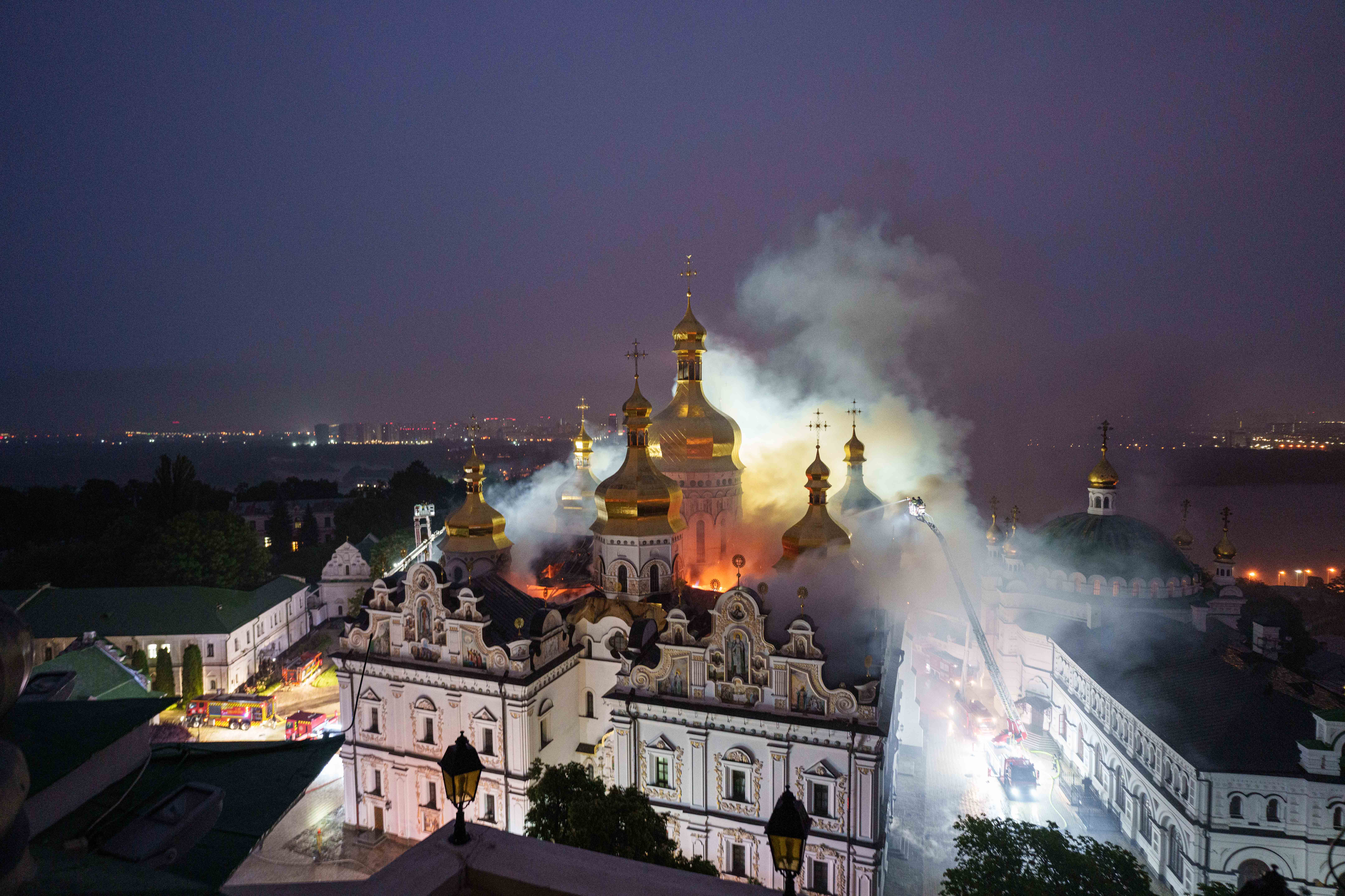 A cathedral burns as firefighters try to put out the fire.