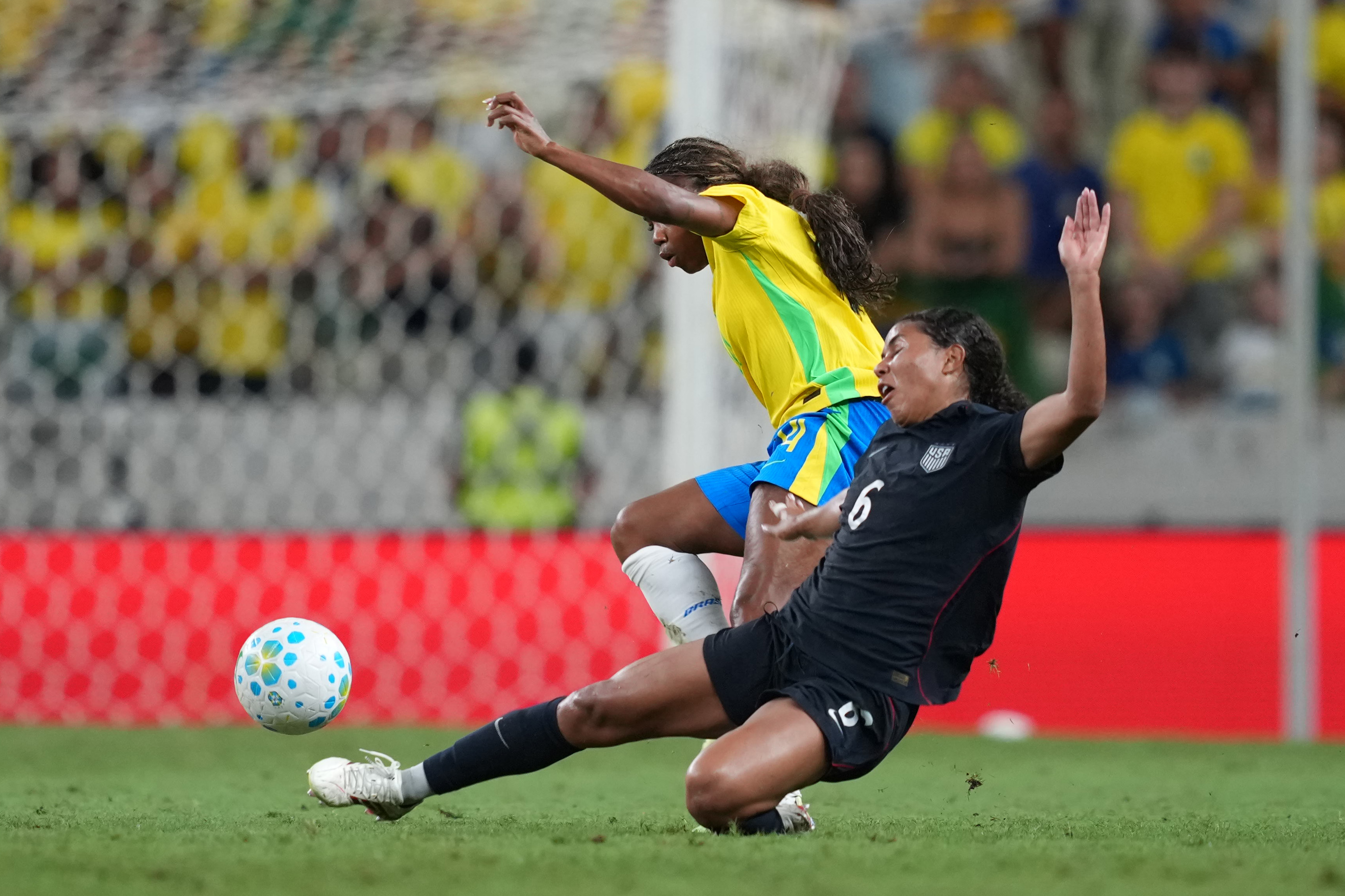 Ludmila of Brazil competes for the ball with Kennedy Wesley of United States