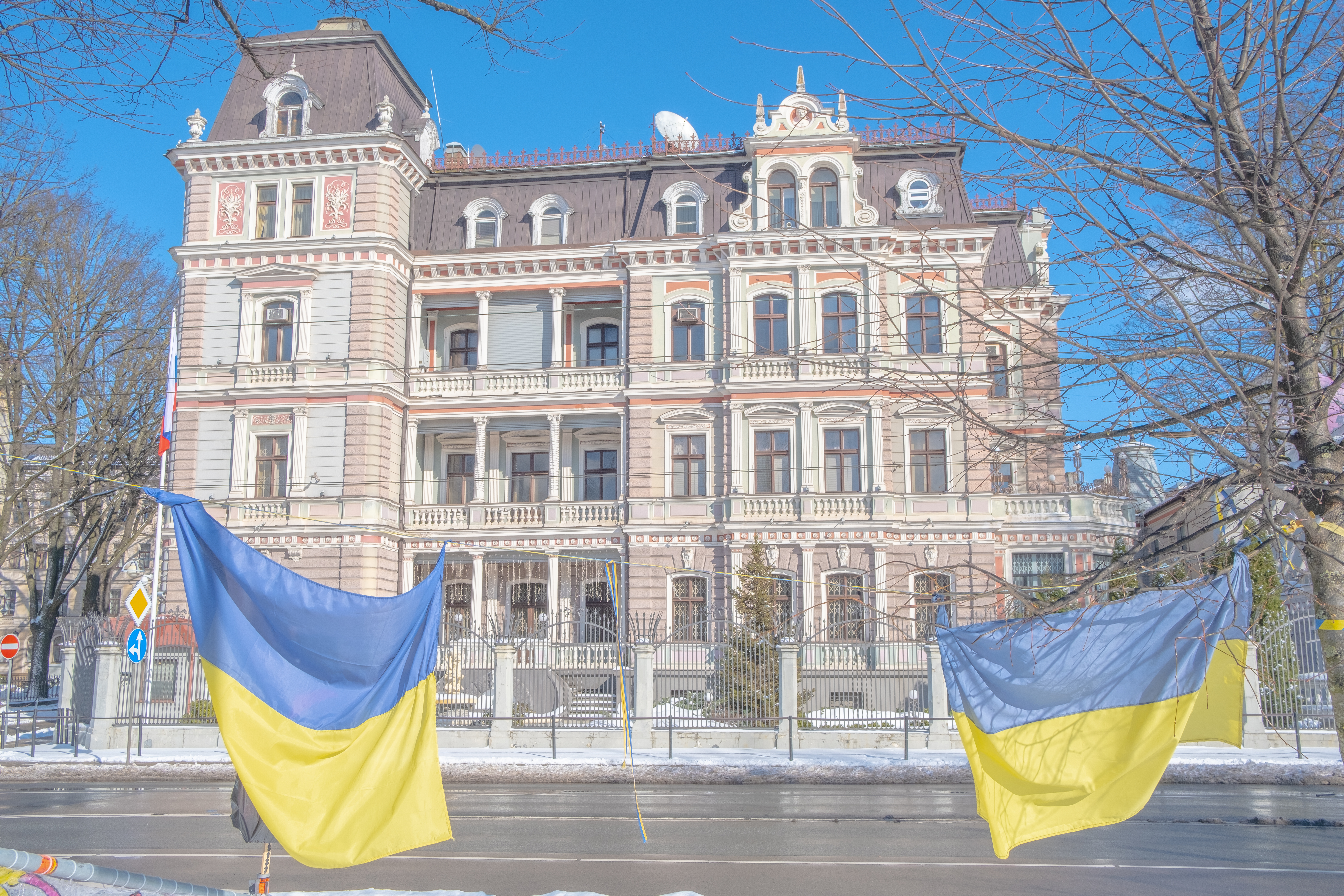 Ukrainian flags hang in front of Russia's embassy in Riga, Latvia