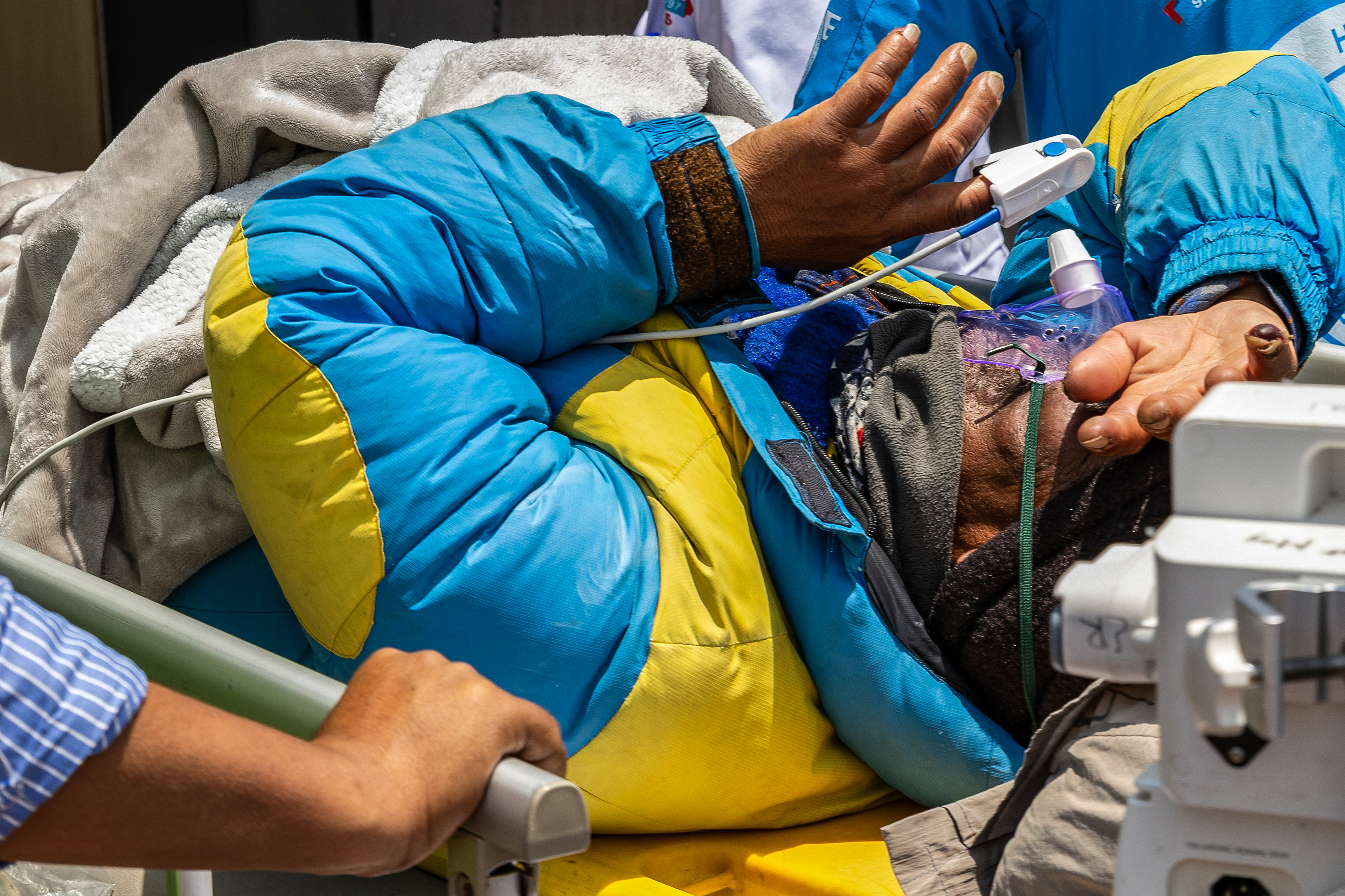 Mountaineer Dawa Sherpa is being carried by medics and rescuers upon his arrival at the HAMS Hospital in Kathmandu on June 4, 2026.