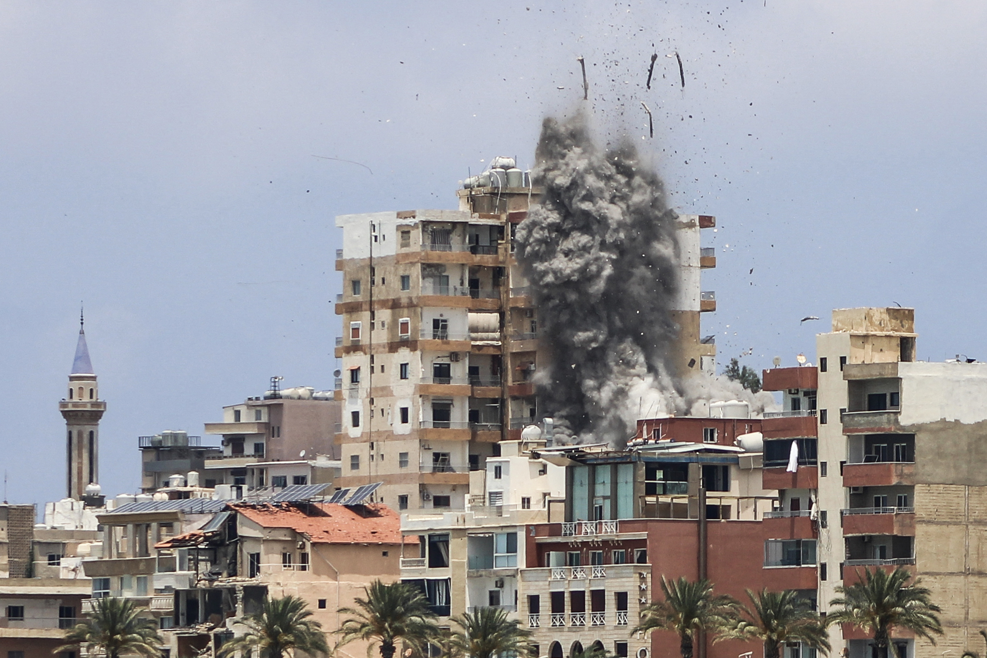 TOPSHOT - Smoke and debris rise following an Israeli airstrike in Tyre on June 9, 2026.