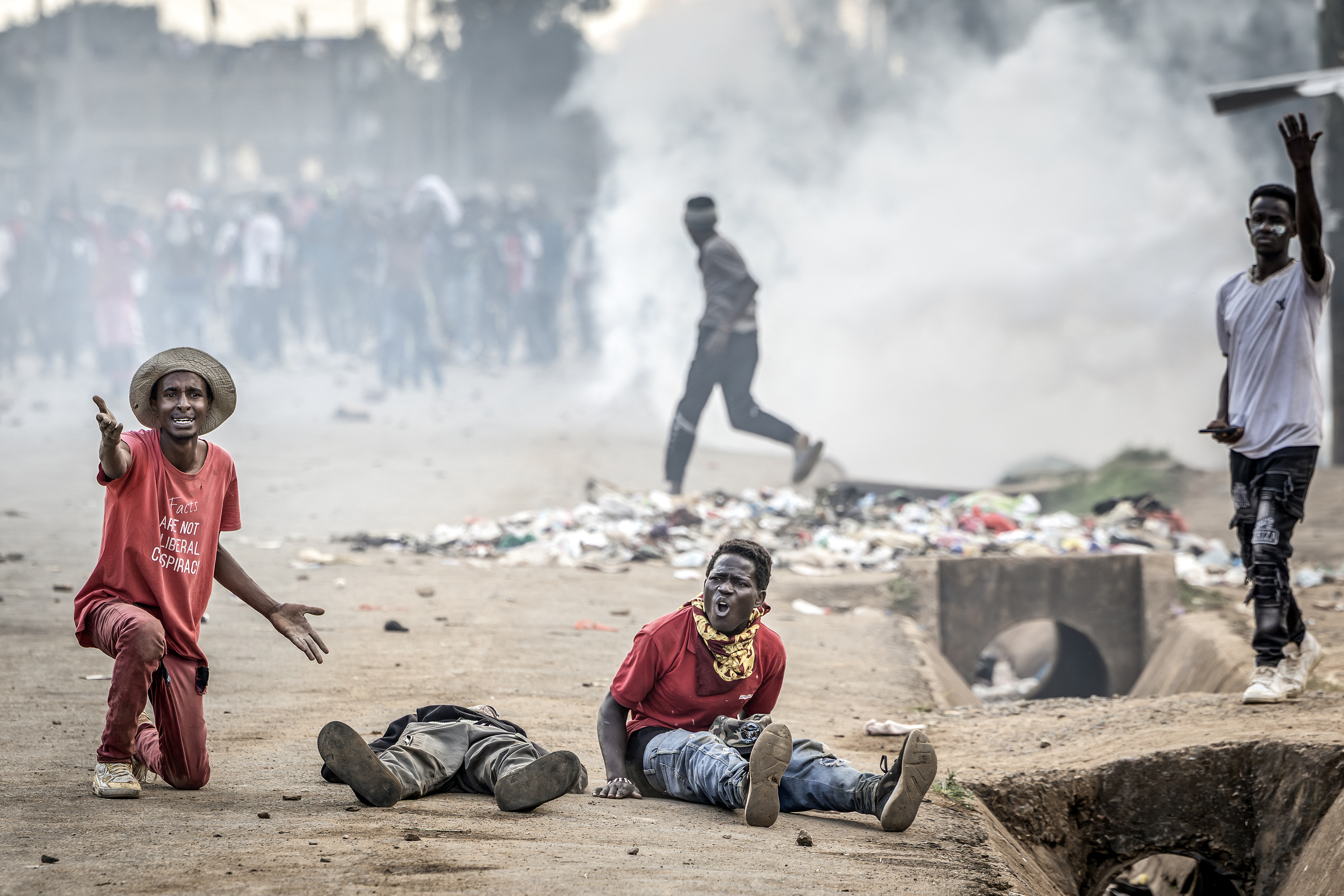 EDITORS NOTE: Graphic content / TOPSHOT - Demonstrators seek for help next to a seriously injured protester as clashes erupt with Kenyan police officers during a demonstration against a controversial US-built Ebola quarantine centre slated to begin operations at Laikipia Air Base in Nanyuki on June 9, 2026.