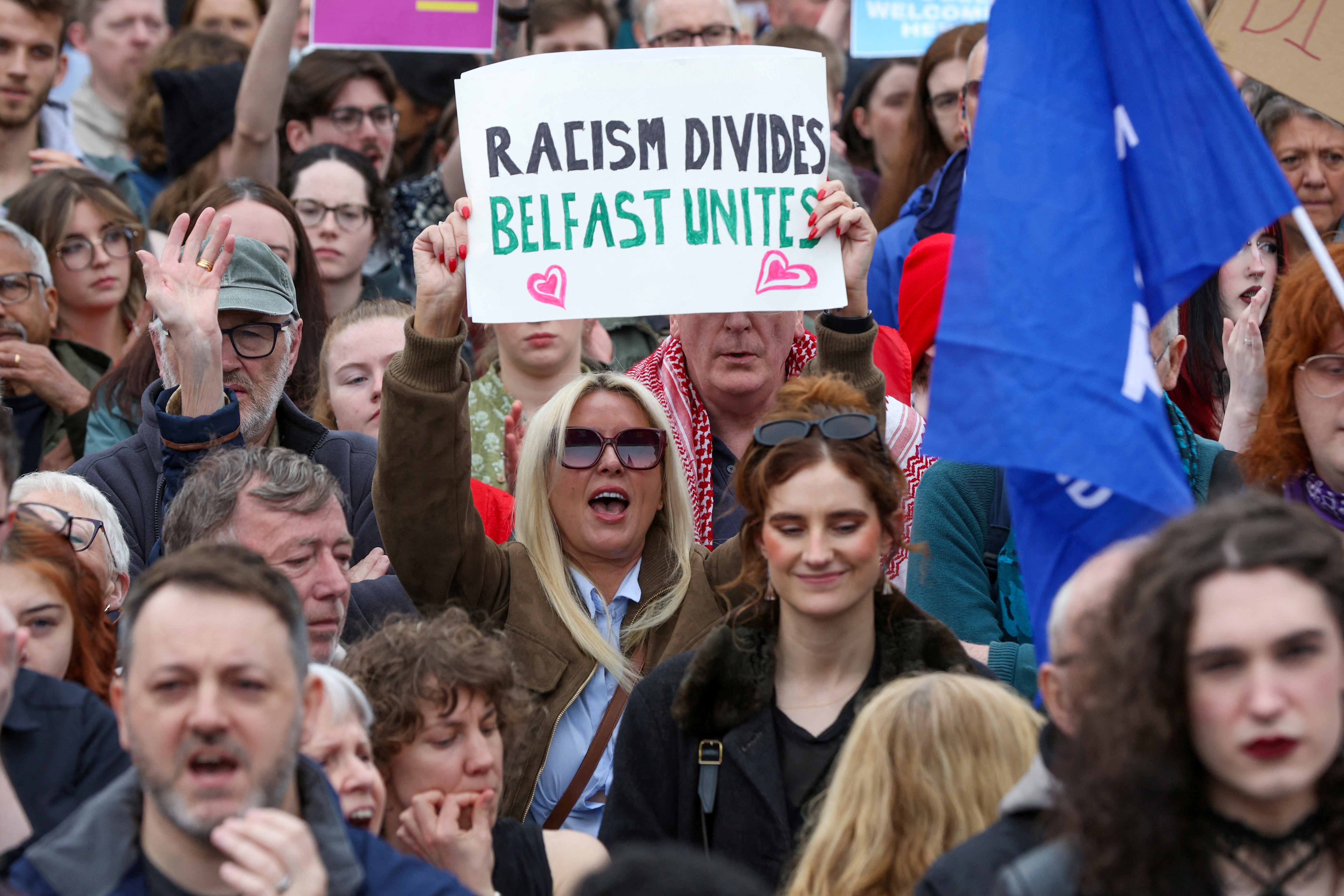 People turn out for a demonstration against racism and call for calm in central Belfast, Northern Ireland on June 13, 2026, after a few nights of disorder hit the city when video of a knife attack on June 8 went viral across social media platforms.