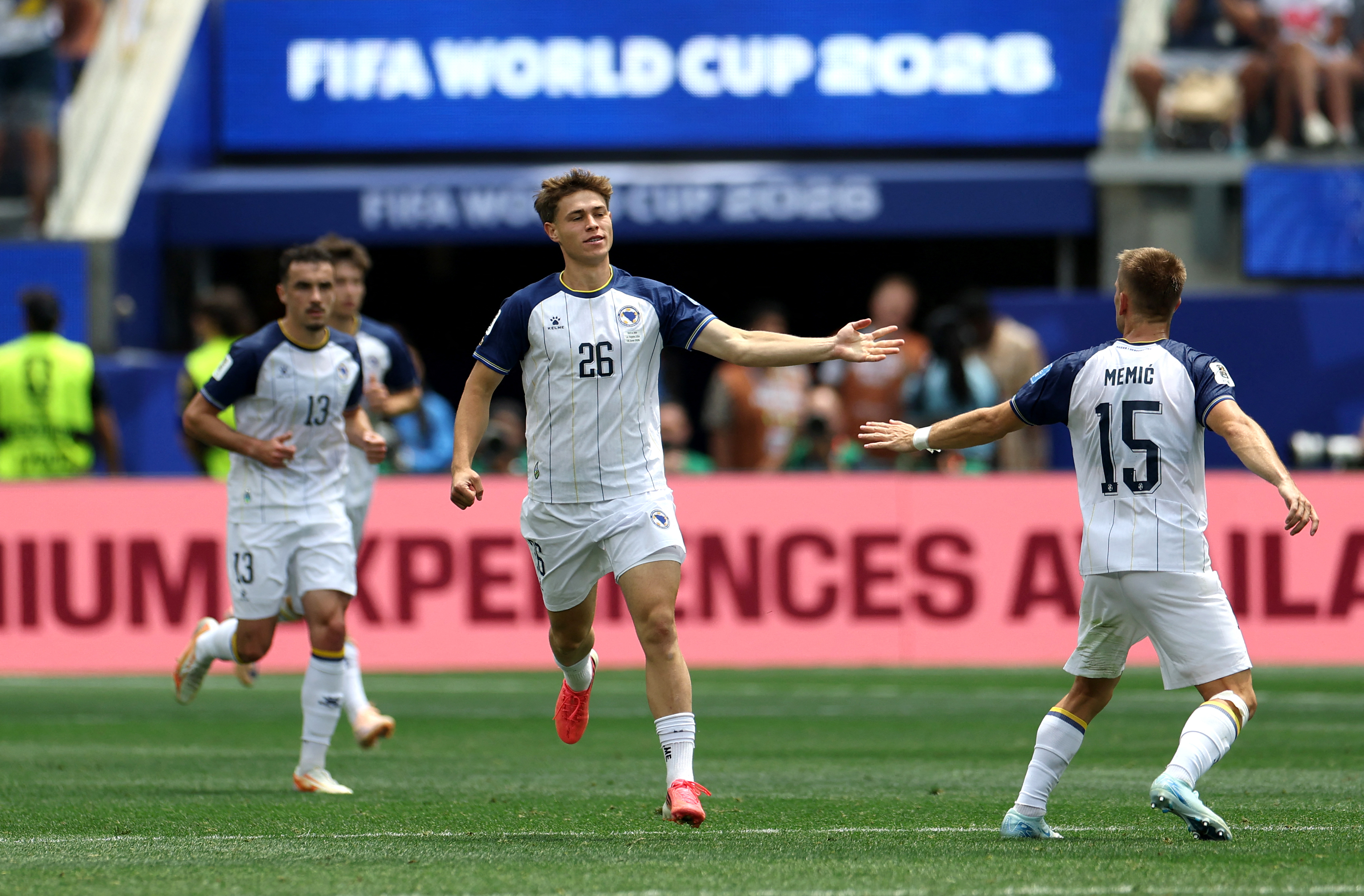 INGLEWOOD, CALIFORNIA - JUNE 18: Ermin Mahmic #26 of Bosnia and Herzegovina celebrates with Amar Memic #15 after scoring the team's first goal during the FIFA World Cup 2026 Group B match between Switzerland and Bosnia and Herzegovina at Los Angeles Stadium on June 18, 2026 in Inglewood, California. Harry How/Getty Images/AFP (Photo by Harry How / GETTY IMAGES NORTH AMERICA / Getty Images via AFP)