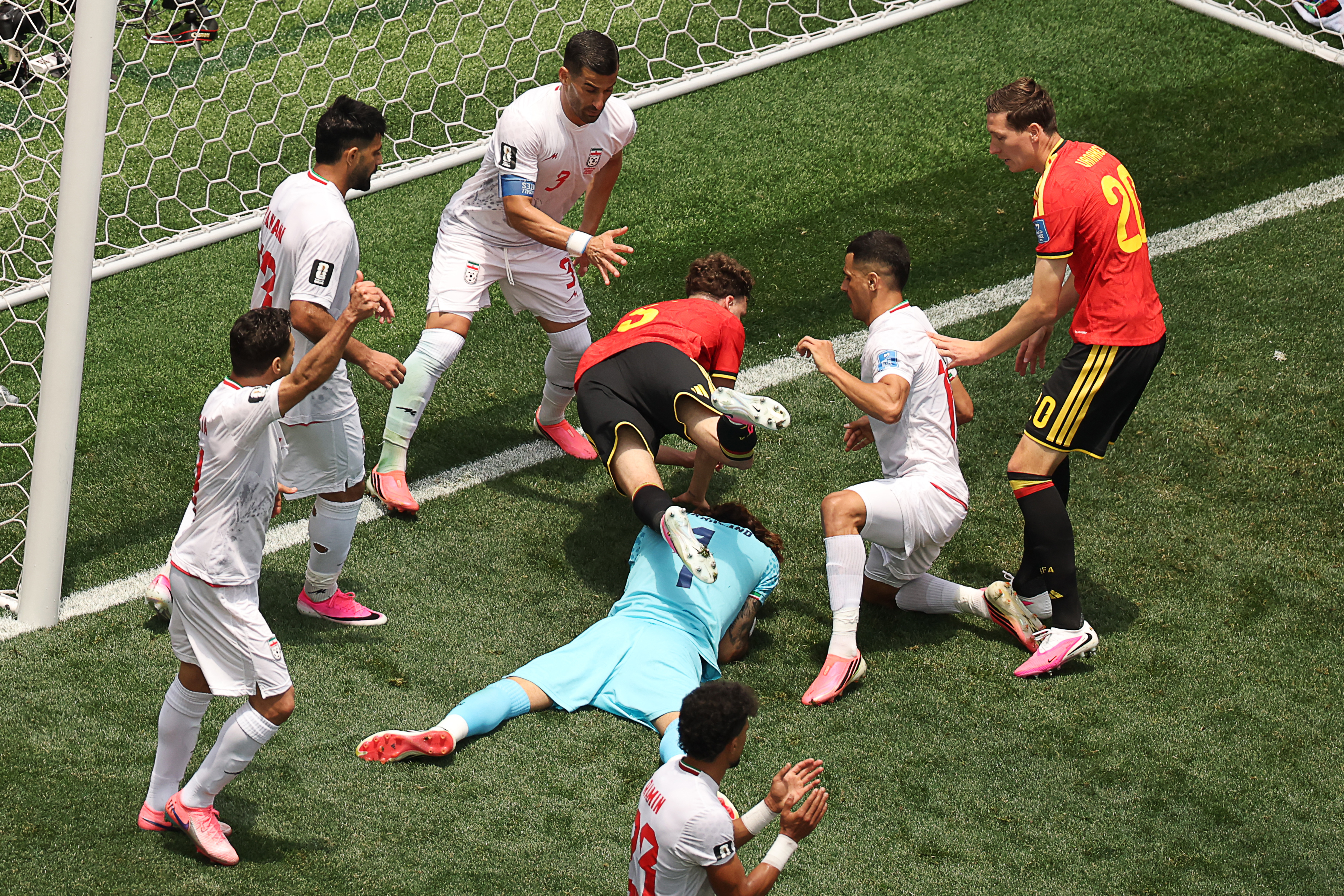 Iran's goalkeeper #01 Alireza Beiranvand makes a save past Belgium's defender #05 Maxim De Cuyper during the 2026 World Cup Group G football match between Belgium and Iran at the Los Angeles Stadium in Inglewood on June 21, 2026.