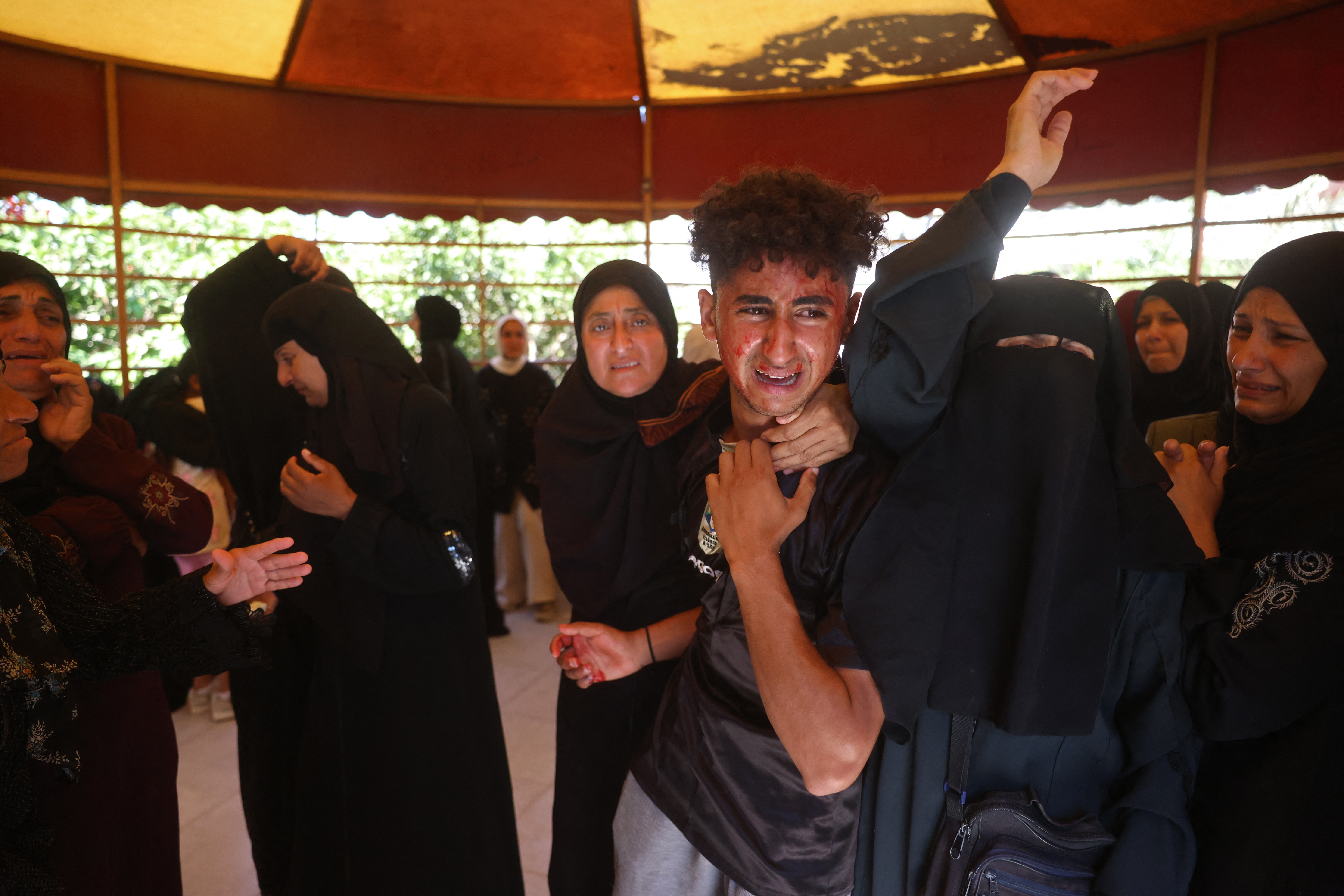 Mourners attend the funeral of 15-year-old Islam Moussa and her brother Abdallah, who were both reportedly killed in an Israeli airstrike, in Khan Yunis in the souhthern Gaza Strip on June 27, 2026.