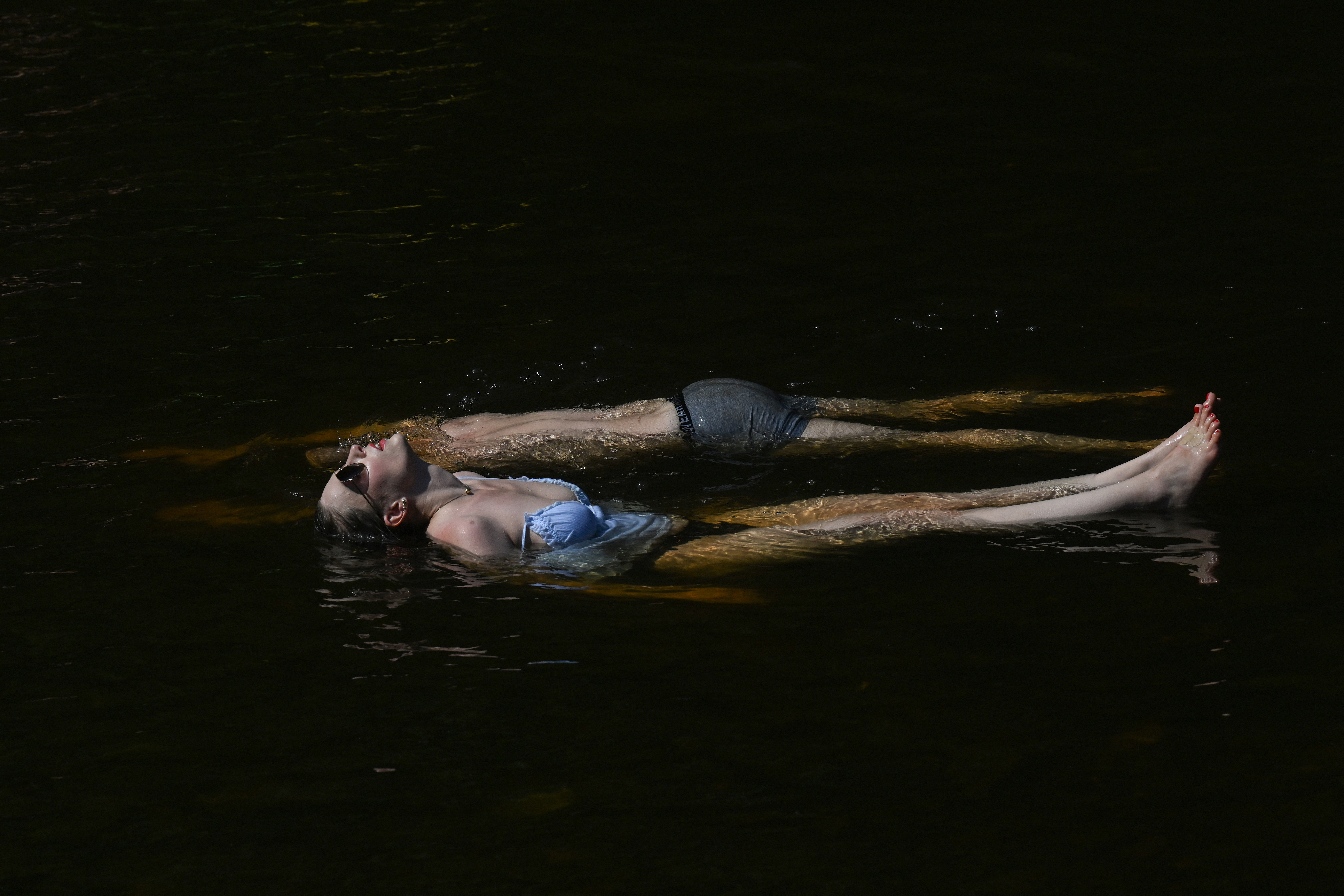 People bathe in a river.