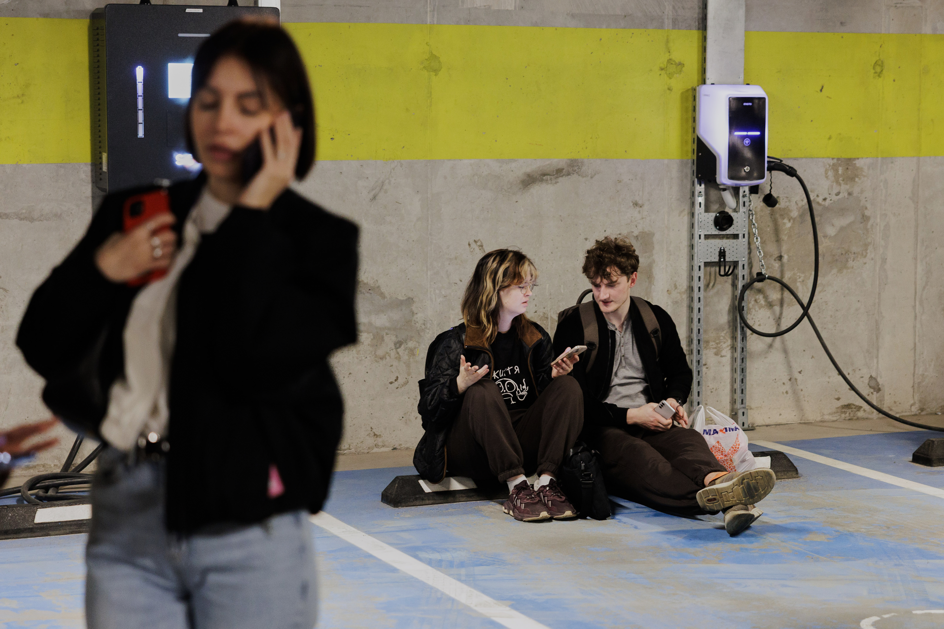 People take shelter in an underground car park during an air raid alert in Vilnius, Lithuania, Wednesday, May 20, 2026. (Vygintas Skaraitis/Lrytas via AP)
