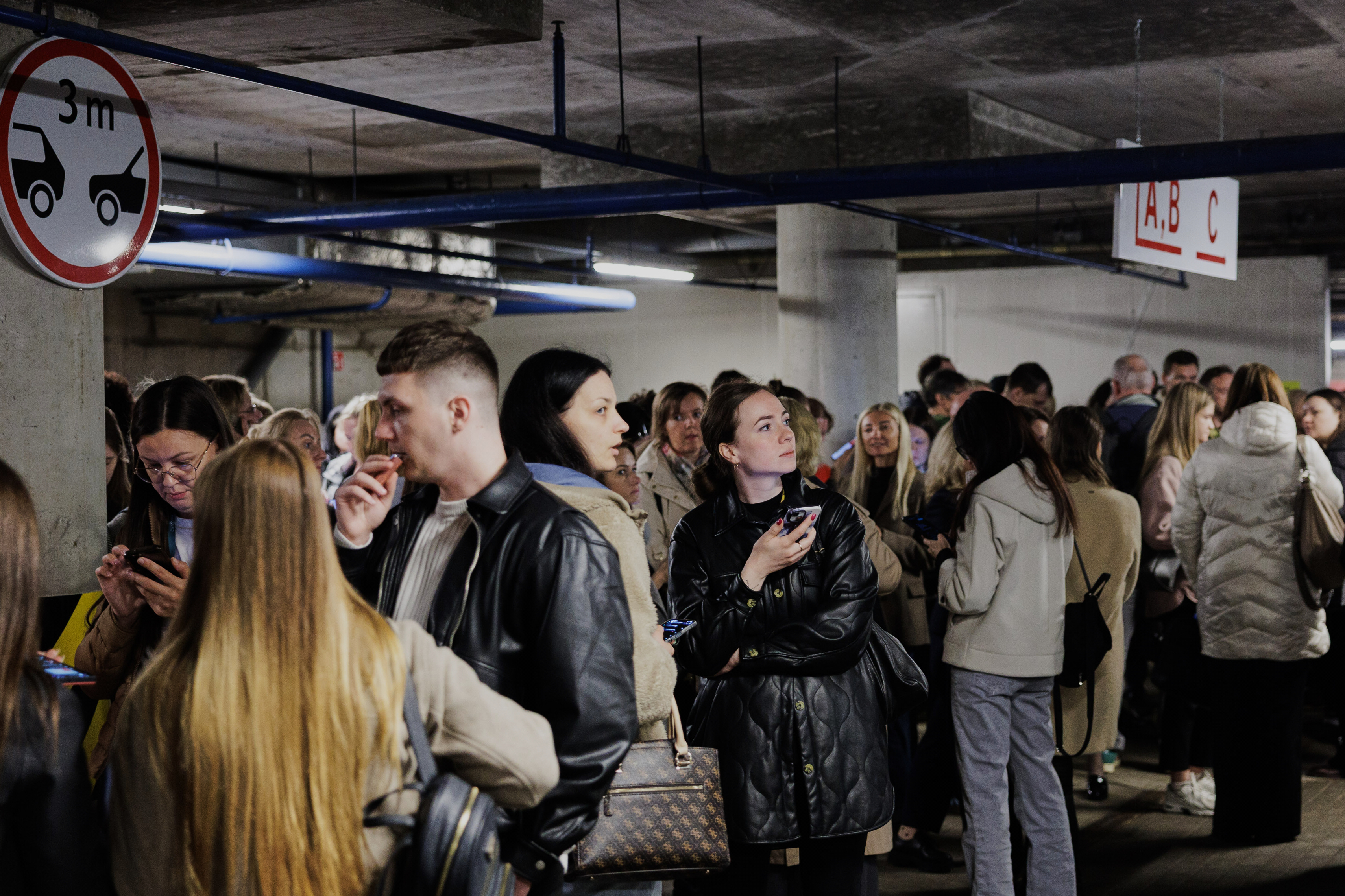 People take shelter in an underground car park during an air raid alert in Vilnius, Lithuania, Wednesday, May 20, 2026. (Vygintas Skaraitis/Lrytas via AP)