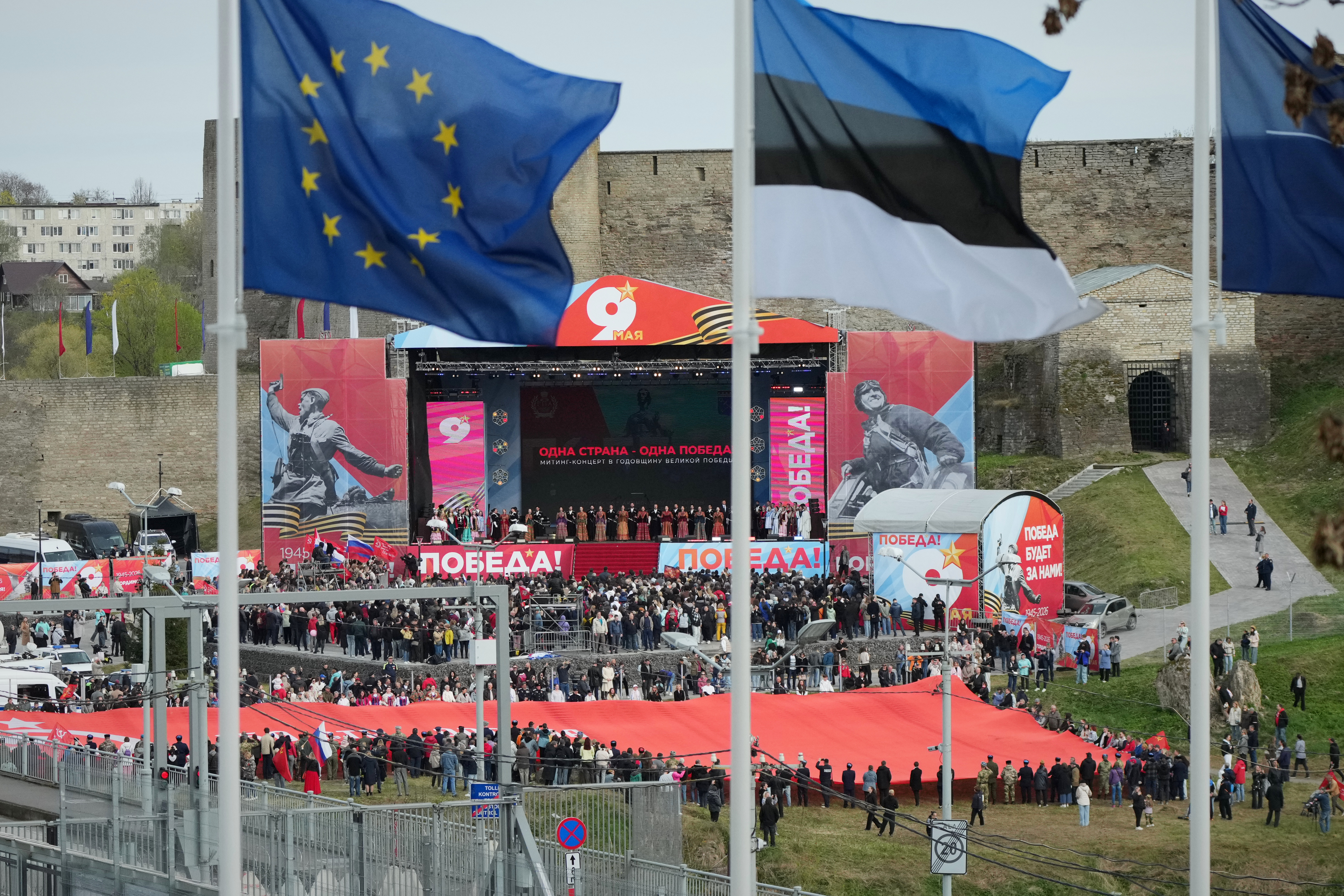 Russian artists perform during a concert celebrating the 81st anniversary of the 1945 victory over Nazi Germany, at a fortress in Ivangorod, Russia, photographed from across the river in Narva, Estonia, on the Russian-Estonian border, on Saturday, May 9, 2026. (AP Photo/Sergei Grits)