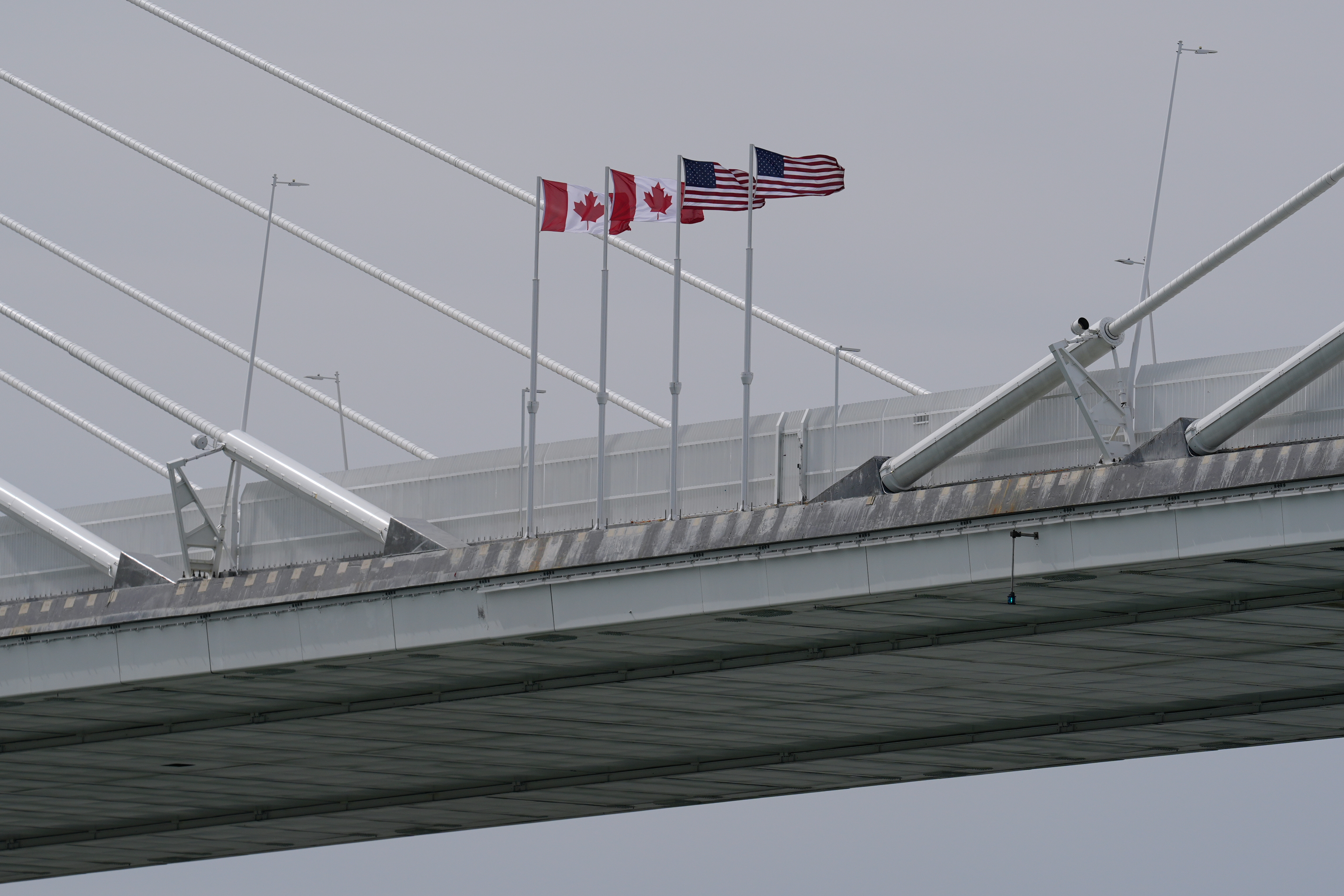FILE - Canadian and American flags are shown on the Gordie Howe Bridge under construction between Windsor, Ontario and Detroit, May 22, 2026. (AP Photo/Paul Sancya, File)