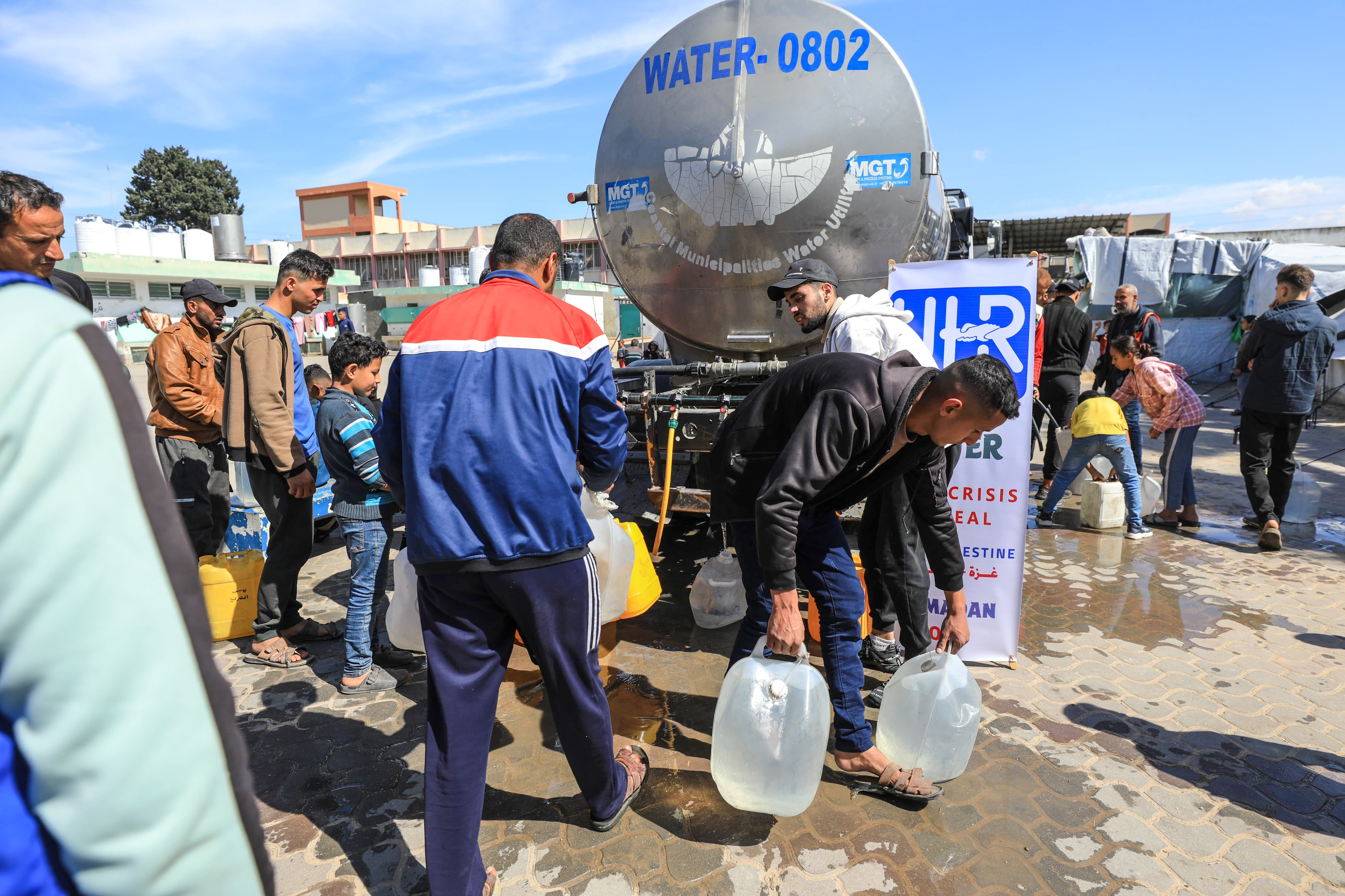 Beneficiaries collect clean water from UHR-sponsored water tanks