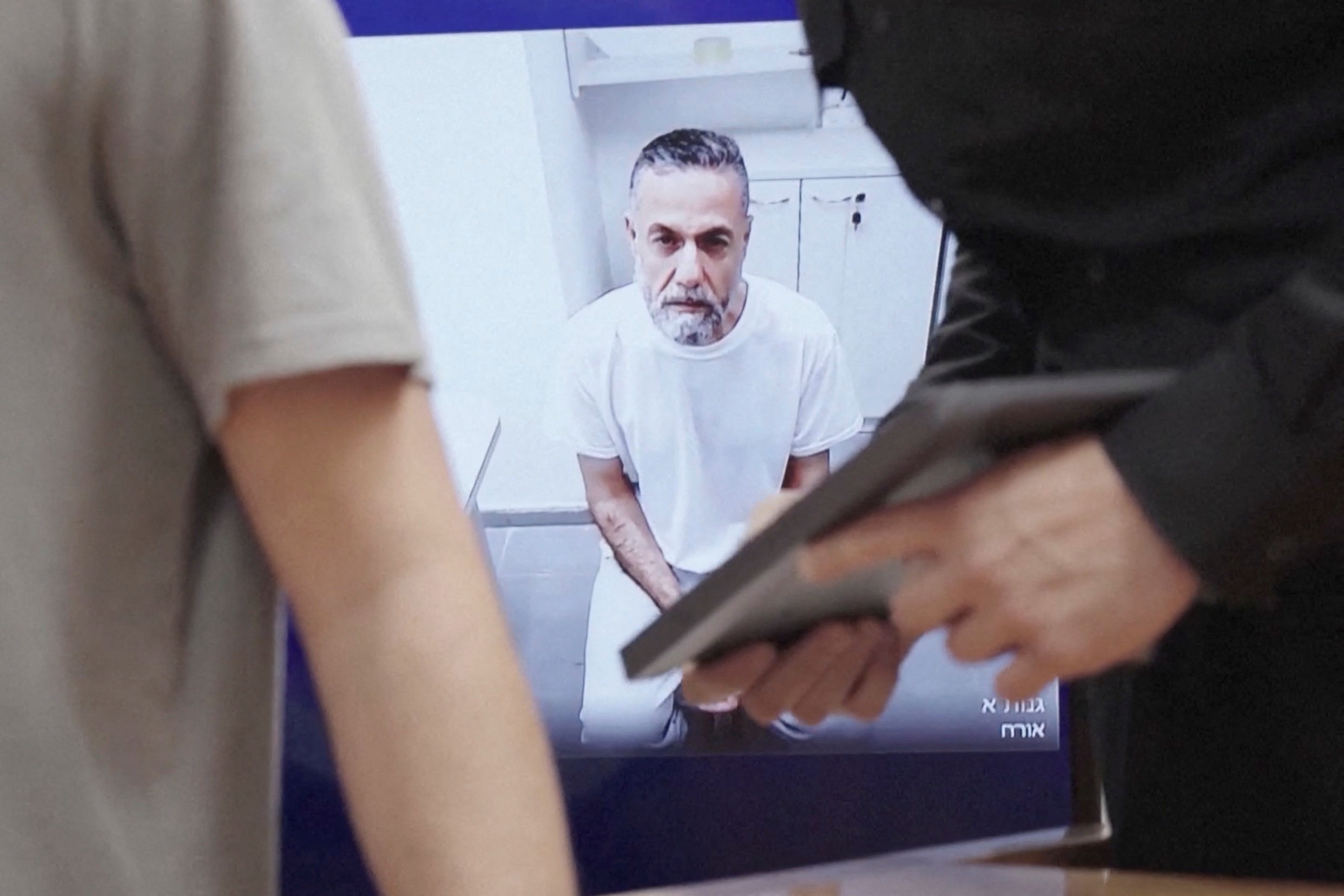 Palestinian doctor Hussam Abu Safiya, who was captured by the Israeli military in Gaza in late 2024 and still held in detention, appears via video link at the Israeli Supreme Court hearing in Jerusalem, June 10, 2026. REUTERS TV via REUTERS