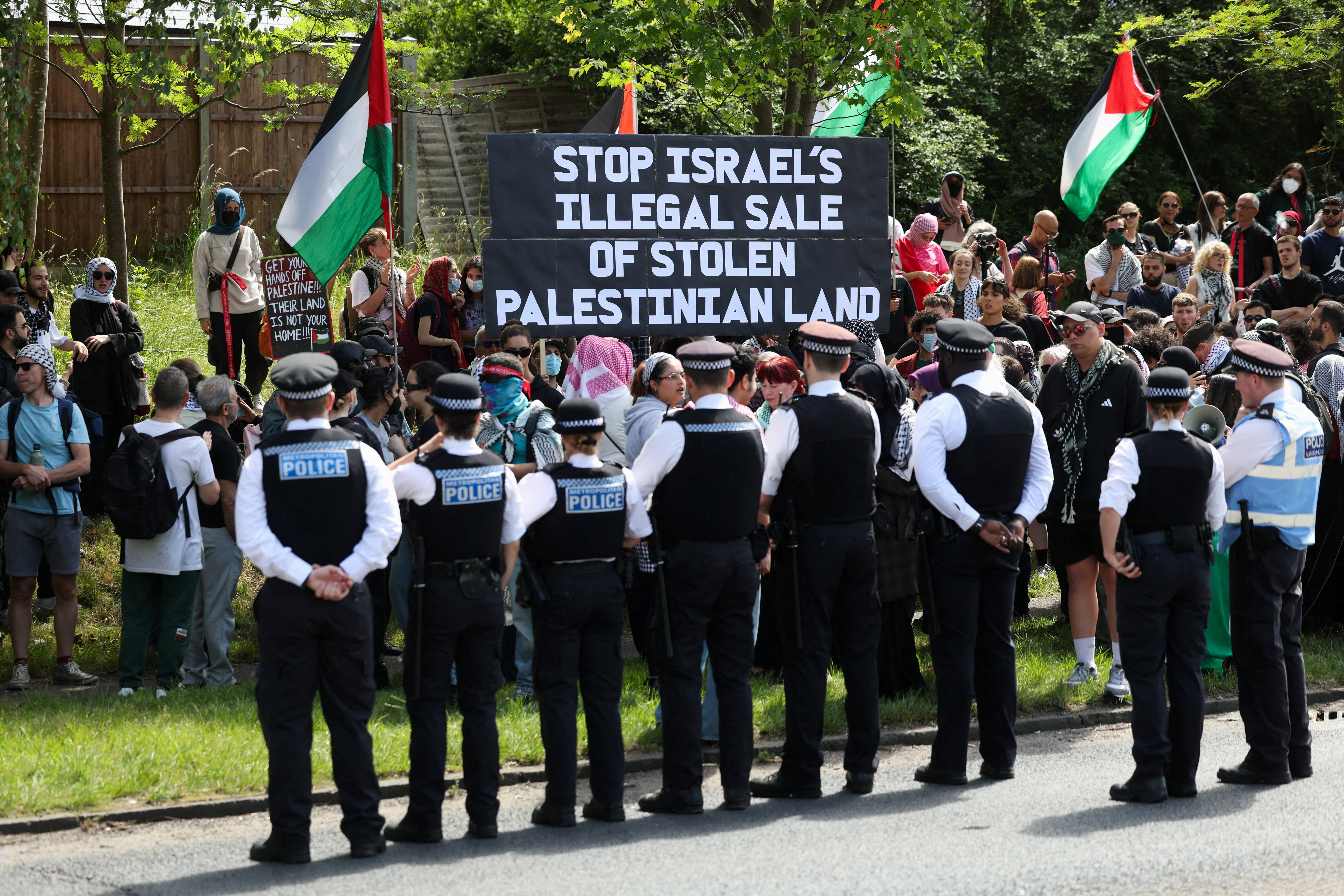 People from pro-Palestinian activist groups gather outside the Edgware United Synagogue, during a demonstration against the "Great Israeli Real Estate Event"