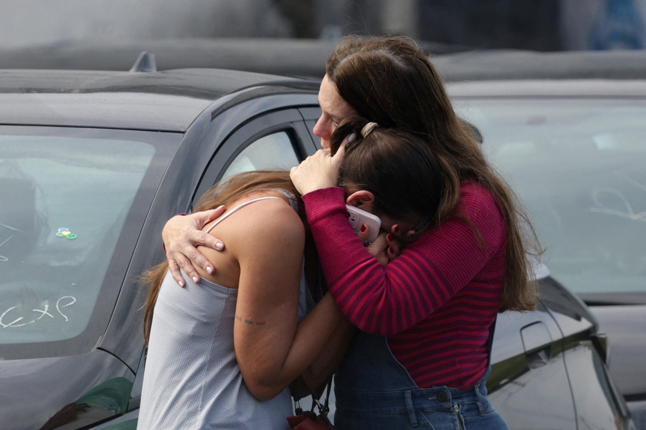 Women embrace following a deadly collision between two helicopters in Rio de Janeiro, Brazil, June 14, 2026. REUTERS/Ricardo Moraes TPX IMAGES OF THE DAY