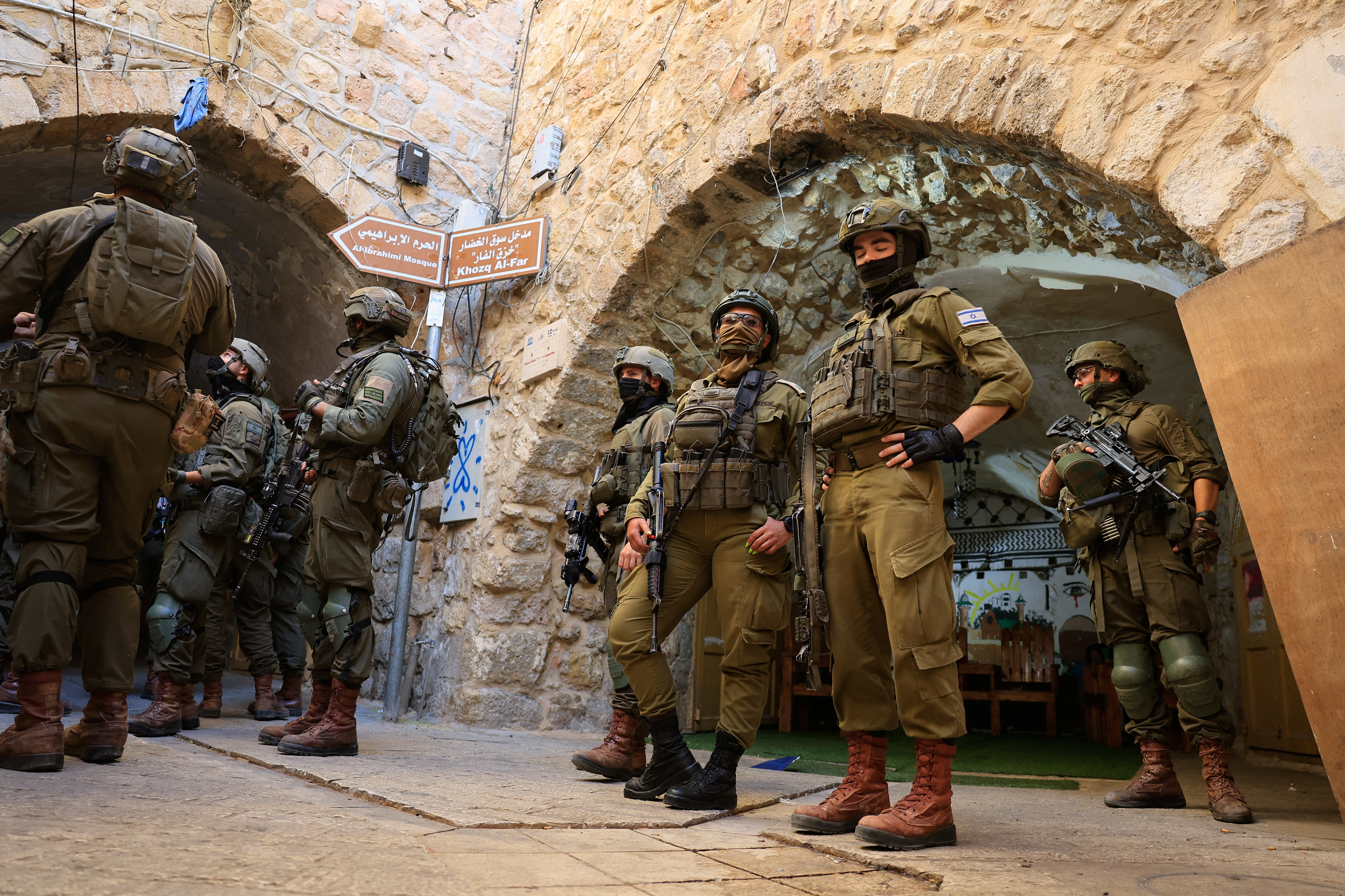 Israeli soldiers keep watch during a weekly Israeli settlers' tour in Hebron, in the Israeli-occupied West Bank, June 20, 2026. REUTERS/Mussa Qawasma