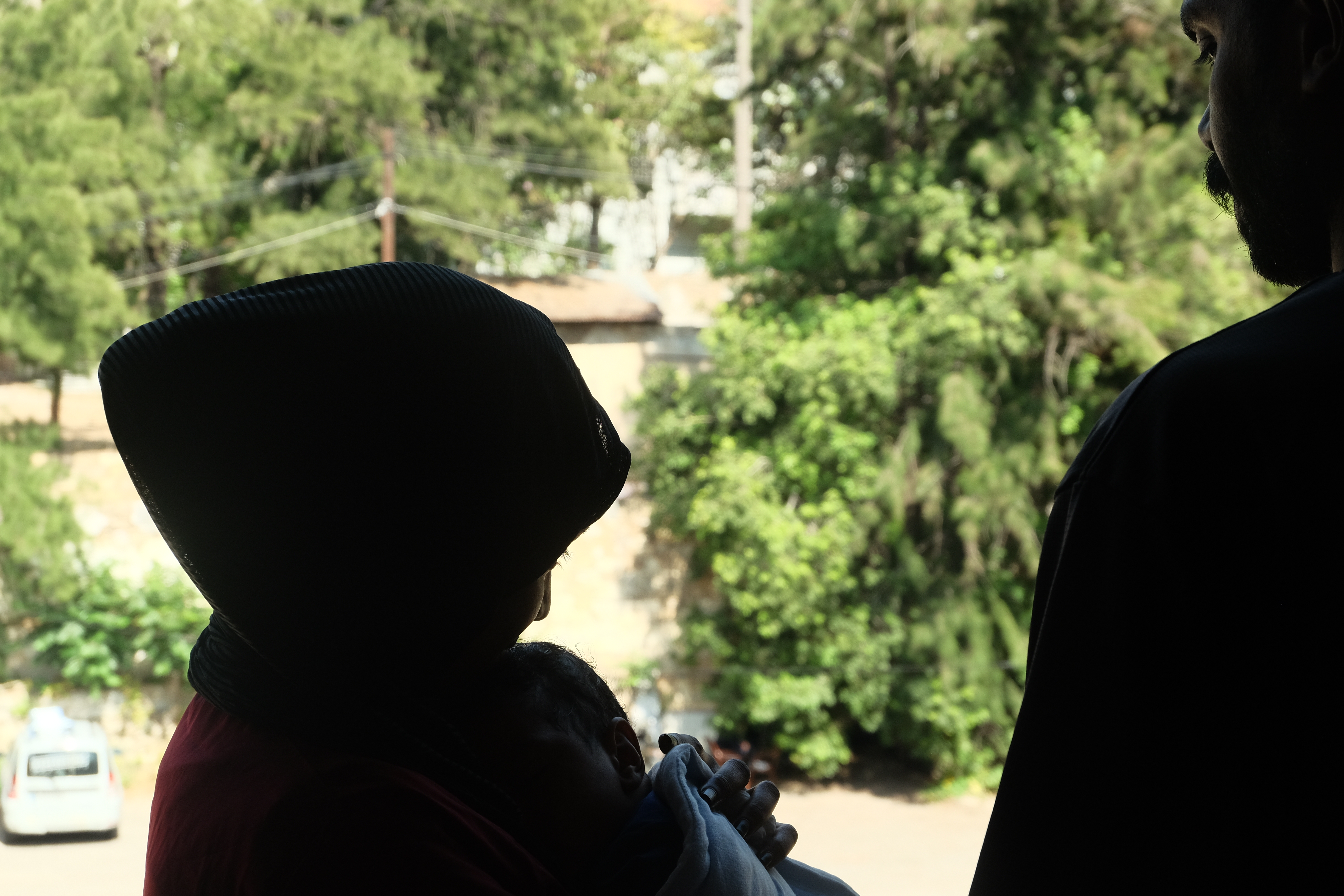 Rufaida, Mohammad and their son Ahmad are pictured in silhouette to conceal their identities over concerns for the safety of family members still in Sudan