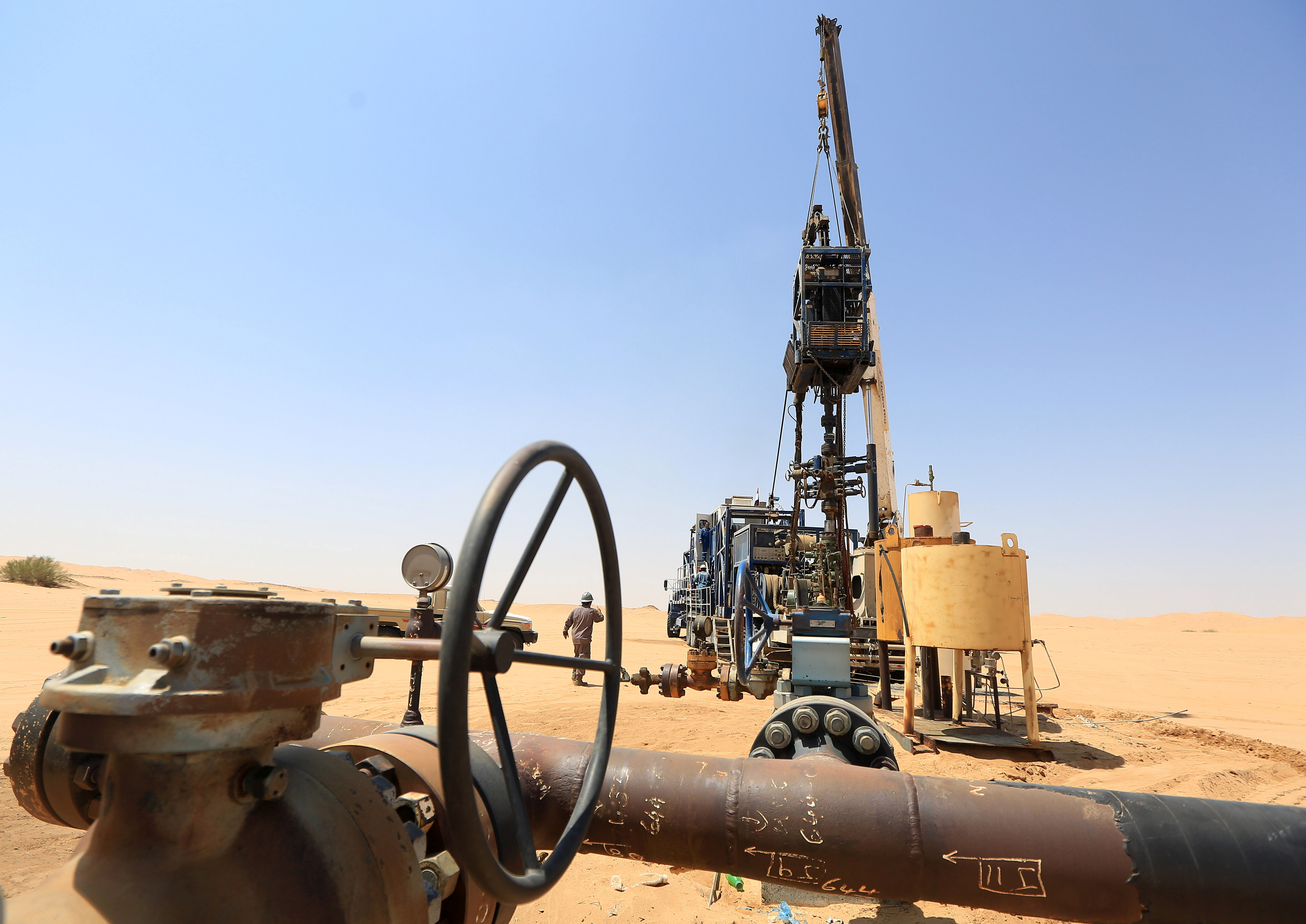 A worker gestures as he stands by a vehicle cleaning an oil well at the Safer oil field in Marib, Yemen September 30, 2020. Picture taken September 30, 2020. REUTERS/Ali Owidha