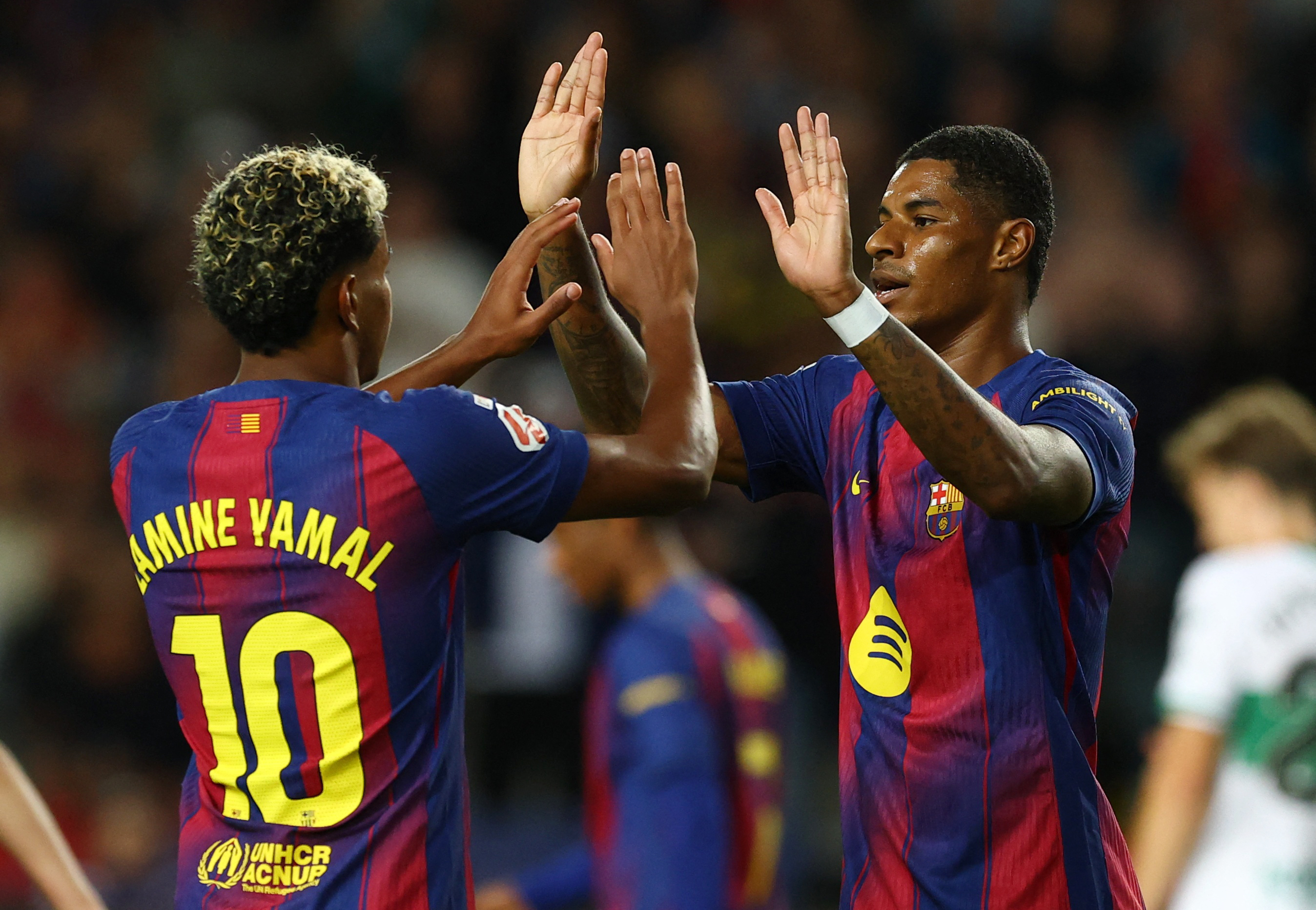 Barcelona's Marcus Rashford celebrates scoring their third goal with Lamine Yamal