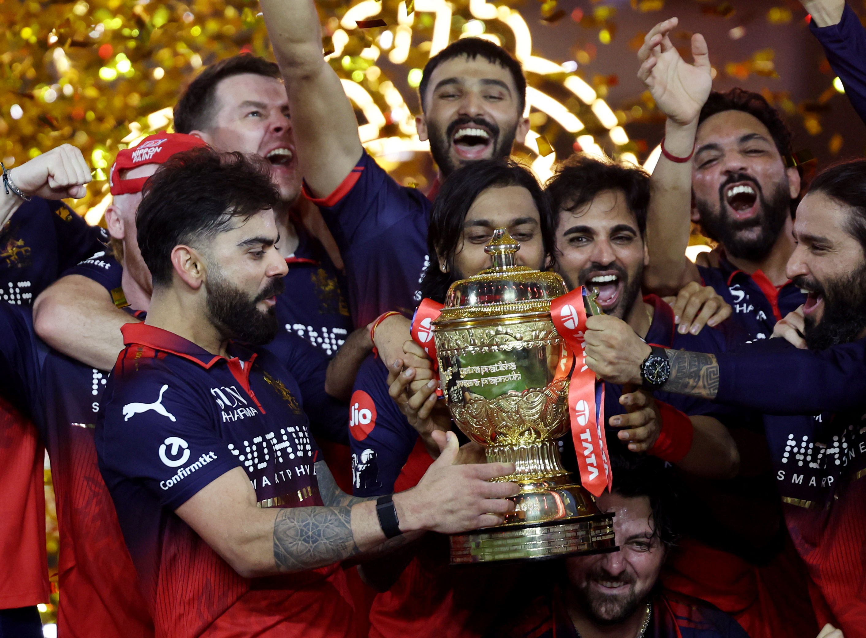 Royal Challengers Bengaluru's Virat Kohli lifts the IPL trophy