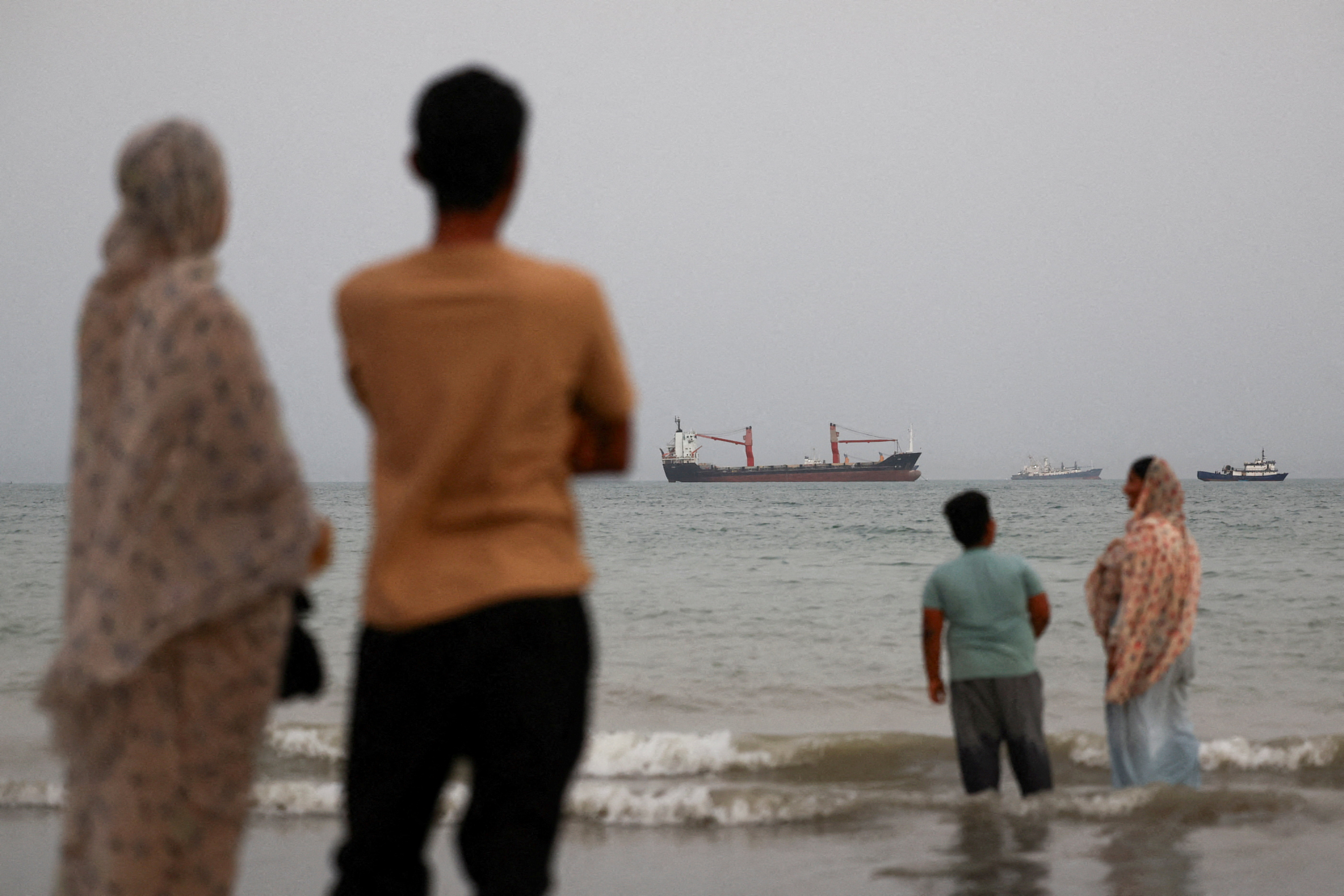 Vessels in the Strait of Hormuz are visible near the beach of Bandar Abbas, Iran, May 22, 2026.