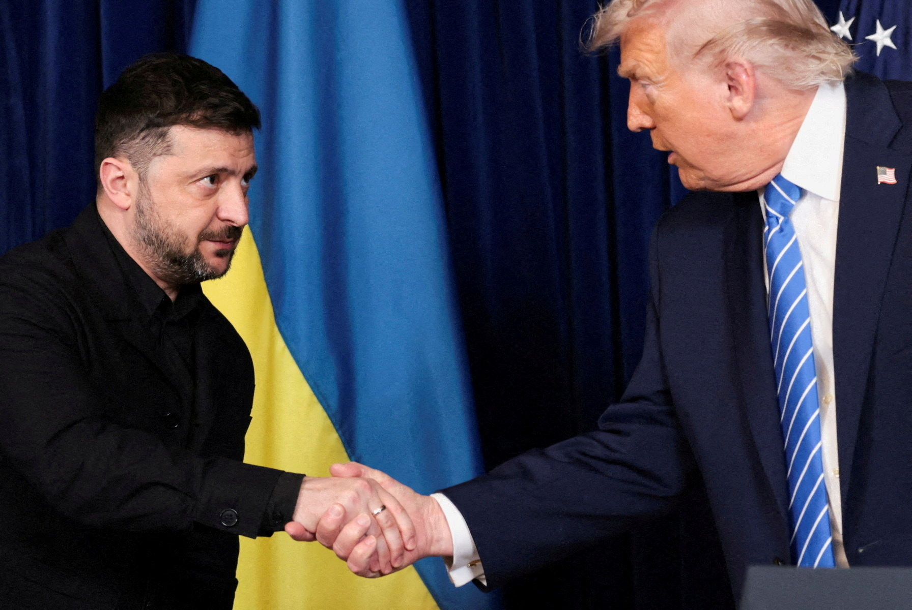 FILE PHOTO: U.S. President Donald Trump and Ukrainian President Volodymyr Zelenskiy shake hands during a press conference after their lunch meeting at Trump?s Mar-a-Lago club, in Palm Beach, Florida, U.S., December 28, 2025. REUTERS/Jonathan Ernst/File Photo
