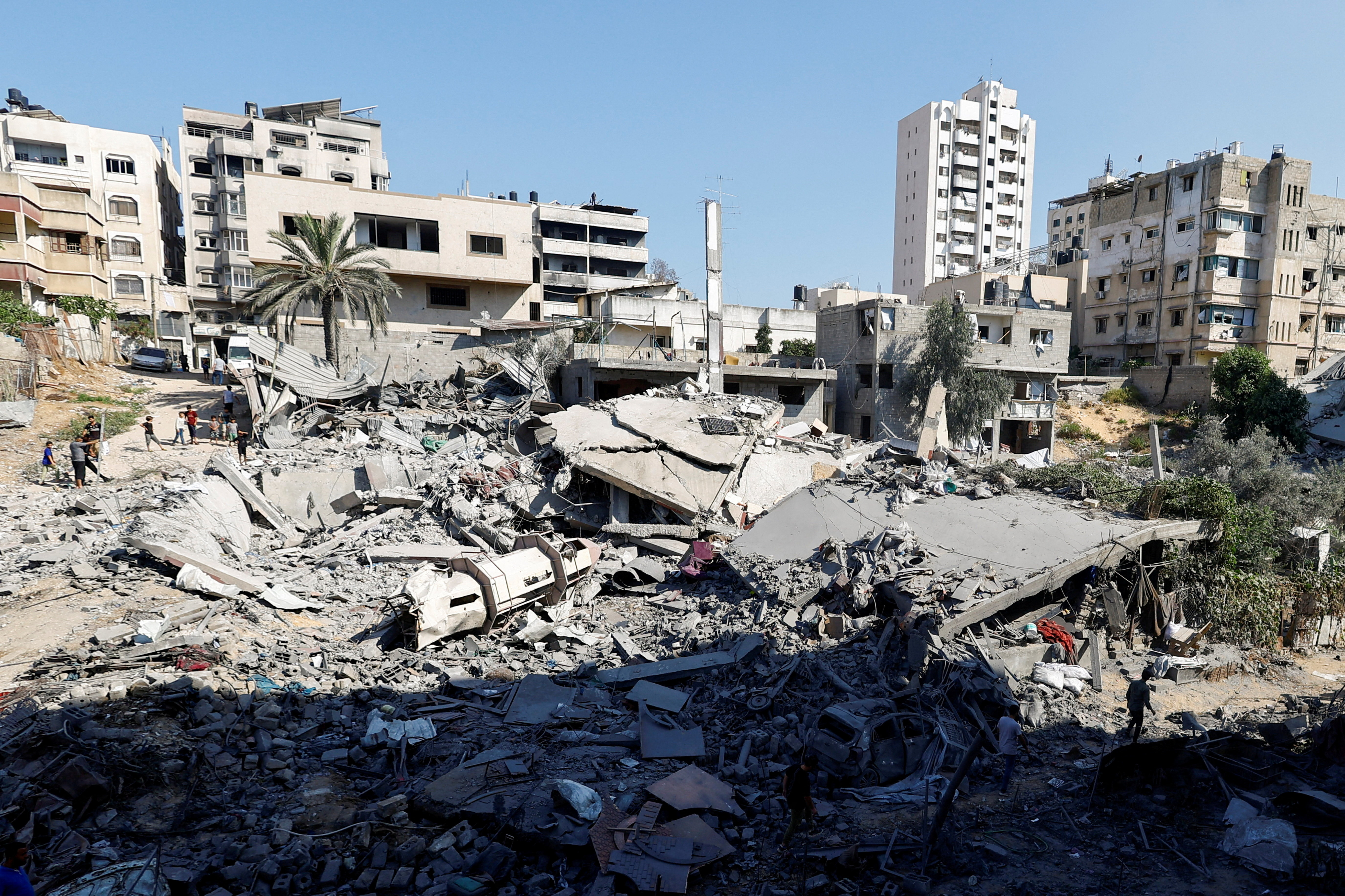 People inspect the site of a bombing.