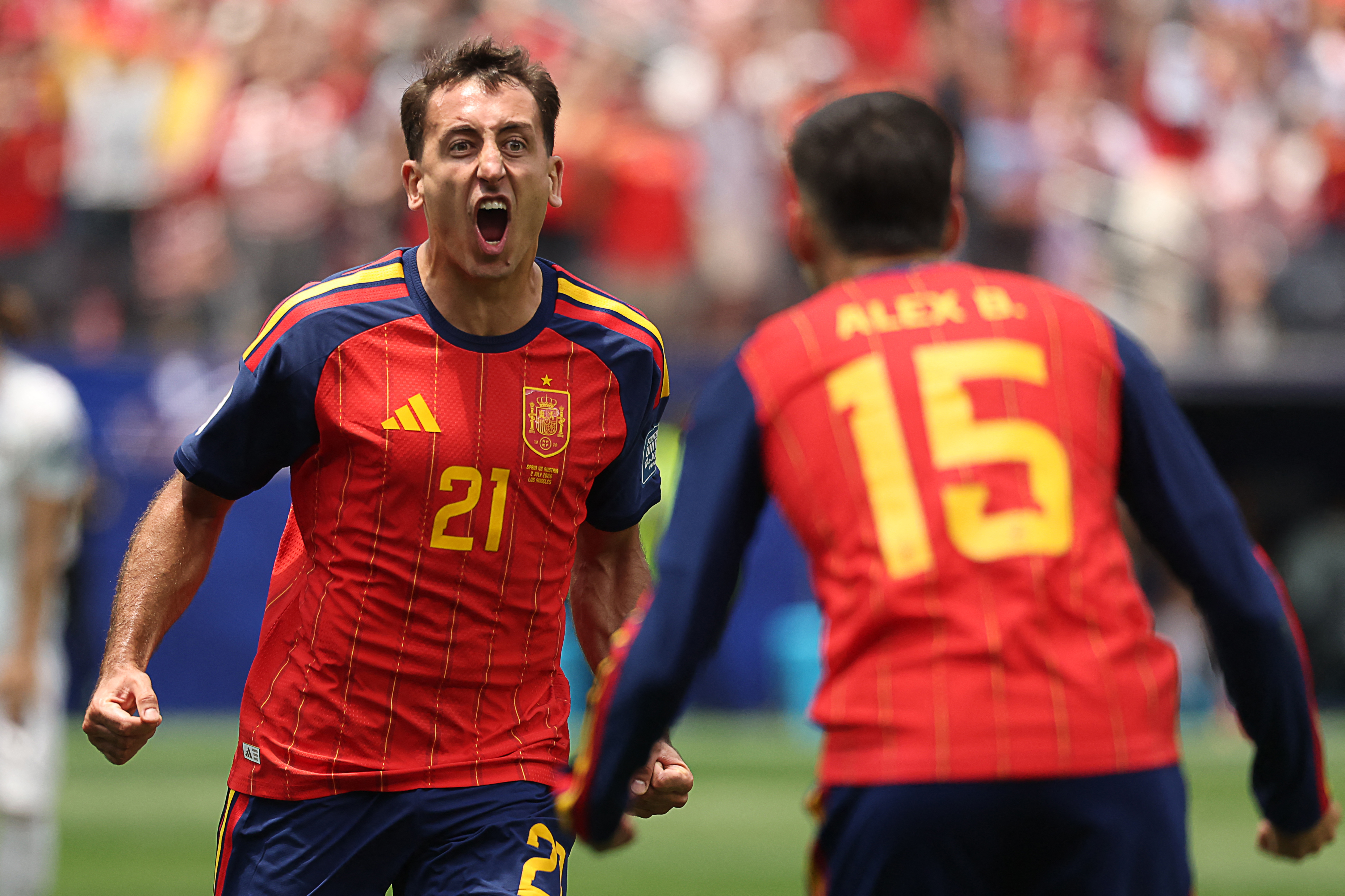 Mikel Oyarzabal, left, celebrates scoring his team’s first goal during the round of 32 match between Spain and Austria