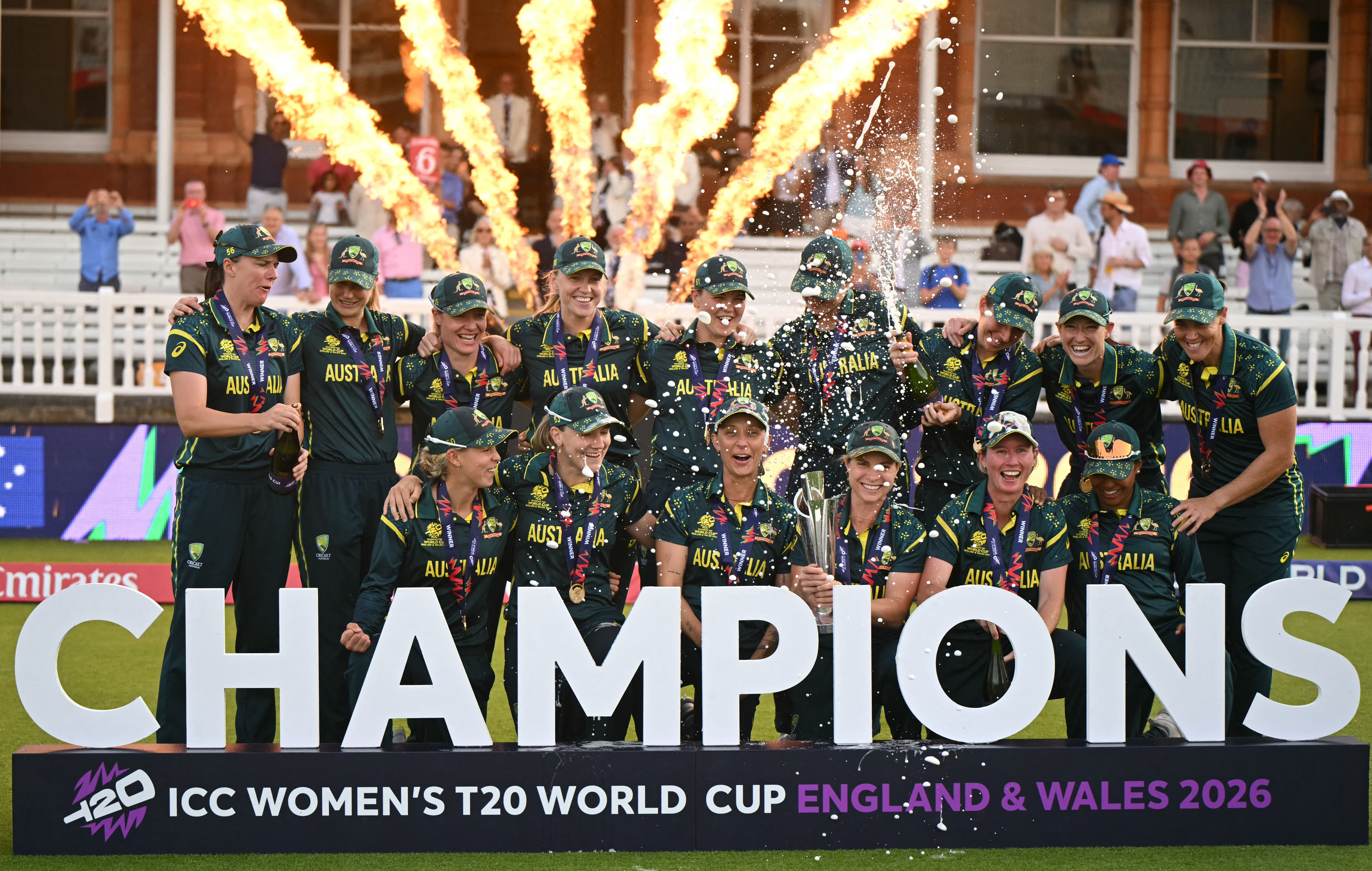 Australia celebrate with the trophy after the ICC Women's T20 cricket world cup 2026 final between Australia and England, at Lord's in London on July 5, 2026. Australia thrashed England by seven wickets to win the Women's T20 World Cup final at Lord's on Sunday. Victory gave Australia a record-extending seventh Women's T20 global title as they chased down a target of 151 with 17 balls to spare. (Photo by JUSTIN TALLIS / AFP)