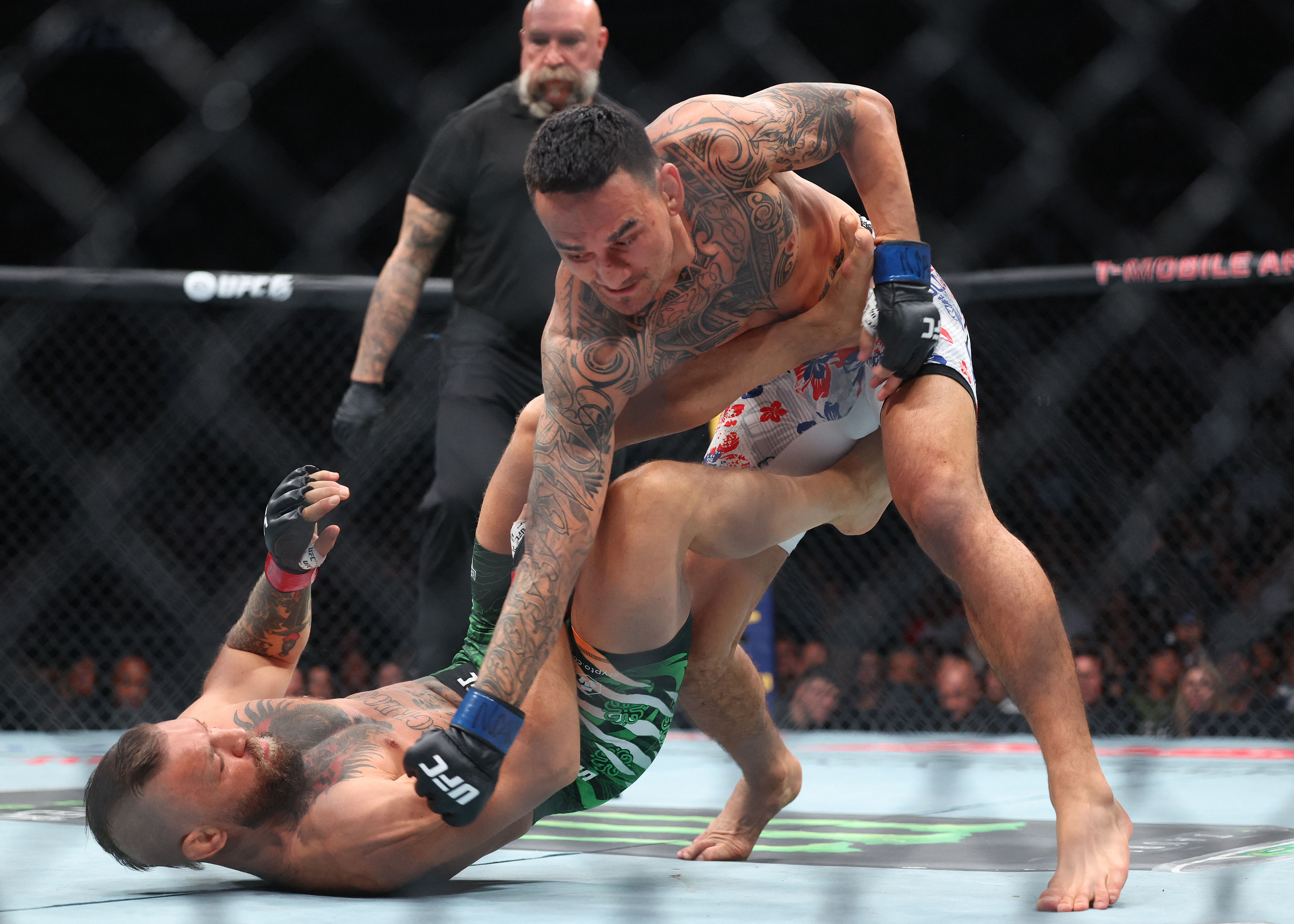 LAS VEGAS, NEVADA - JULY 11: Max Holloway of the United States lands a punch on Conor McGregor of Ireland during the first round in their welterweight bout during UFC 329 at T-Mobile Arena on July 11, 2026 in Las Vegas, Nevada. Ian Maule/Getty Images/AFP (Photo by Ian Maule / GETTY IMAGES NORTH AMERICA / Getty Images via AFP)