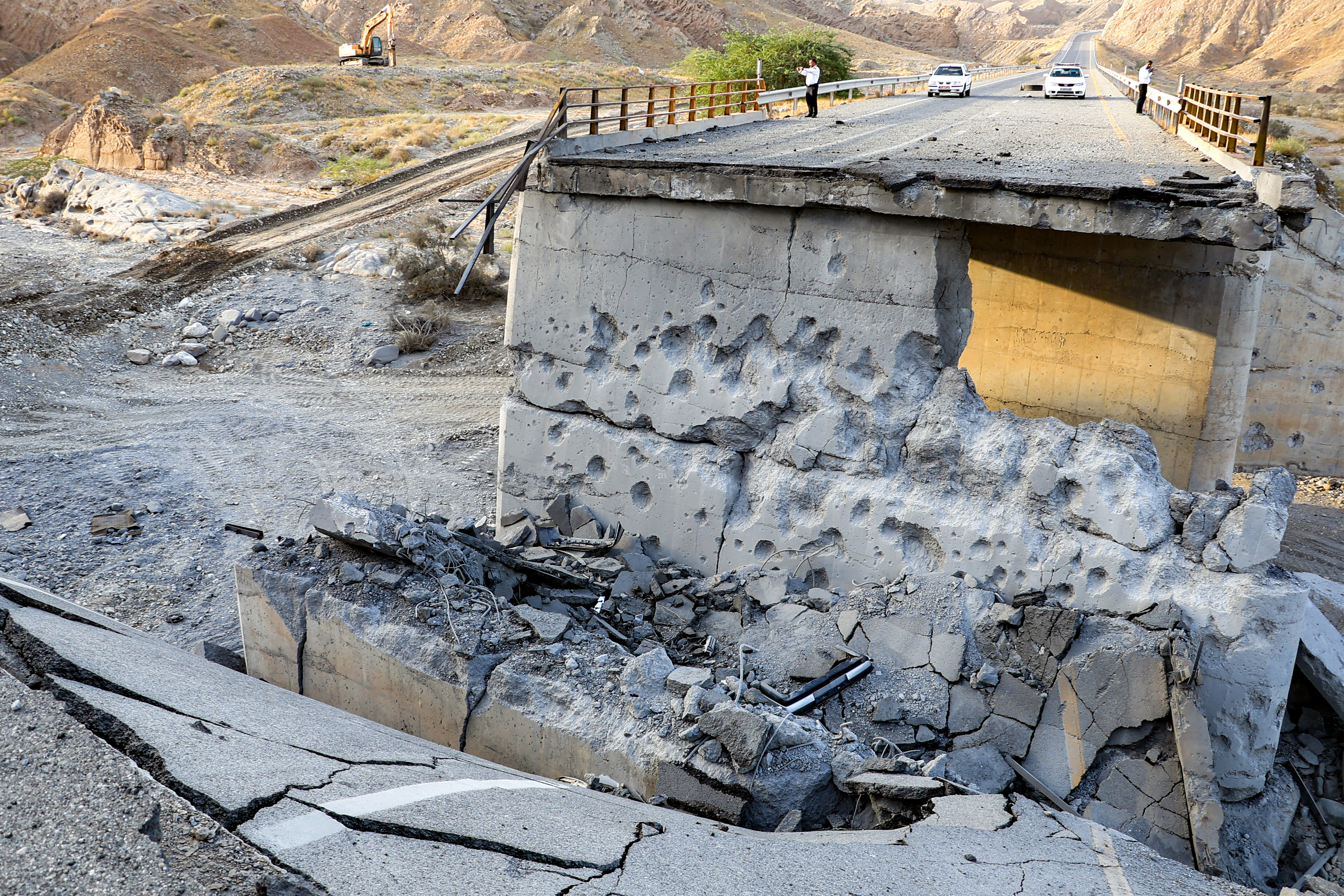 A heavily-damaged bridge which was hit by a US strike is pictured along the road connecting Roudan and Bandar Abbas in southern Iran on July 18, 2026. The United States hit Iran on July 17, with Tehran accusing US forces of striking civilians sites and drawing Iranian threats of reprisals on regional infrastructure. A battle over the strategic Strait of Hormuz has rekindled the war in the Middle East and the foes have traded fire for six days running. (Photo by Amir Hossein KHORGOOEI / ISNA / AFP) /