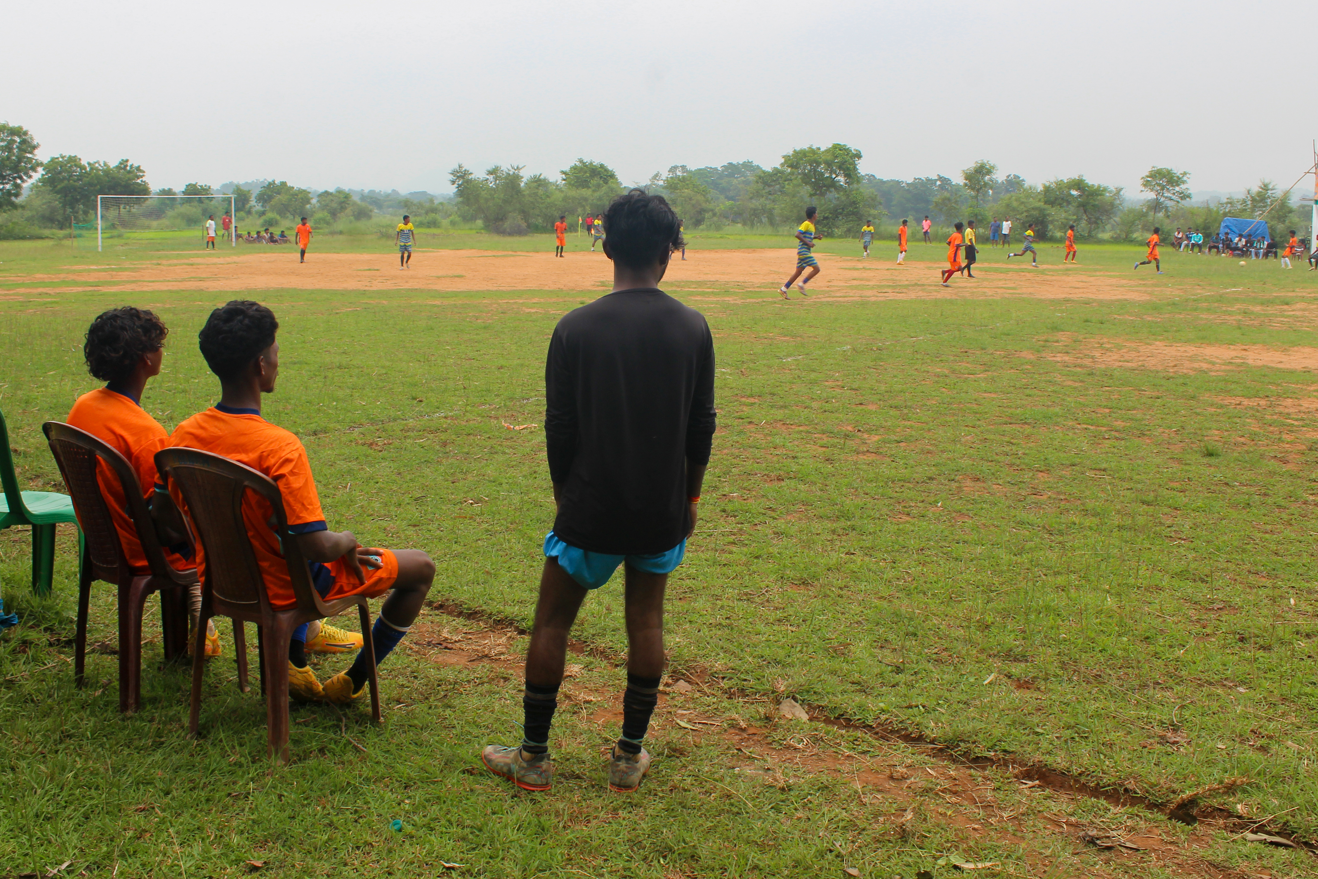 Competing teams play a football match at the Rangila Star Tirilbasa tournament in Chaibasa, Jharkhand, India