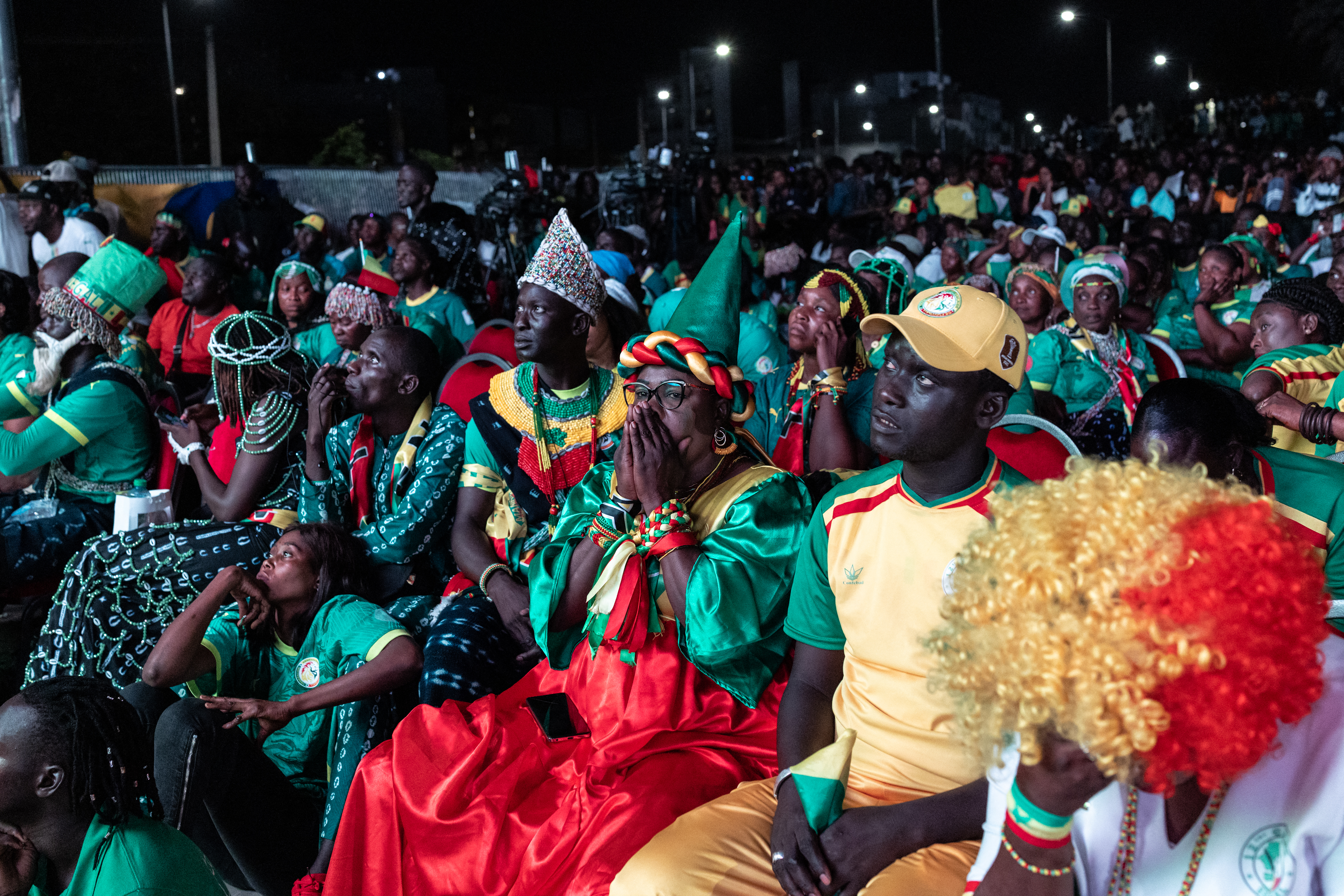Senegal supporters react after their team lost the 2026 World Cup round of 32 football match against Belgium as they watch the game at the FIFA Fan Zone at the Place de l'Obelisque in Dakar on July 1, 2026.